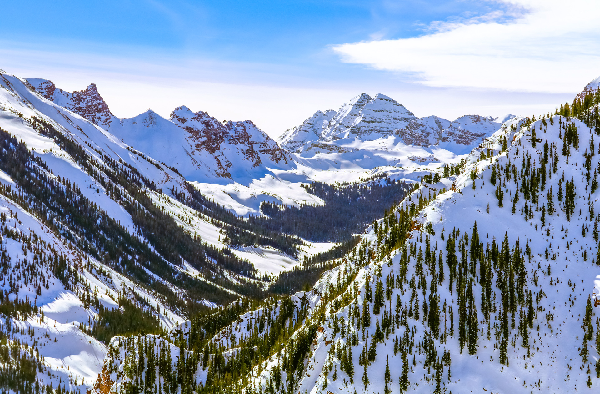 Colorado mountain peaks dotted with green trees in the winter