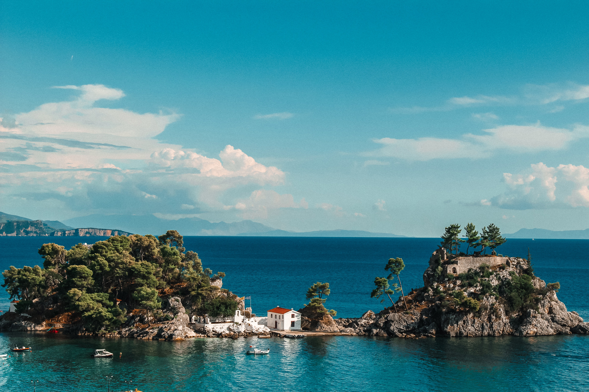 A small rocky island with a house in the middle