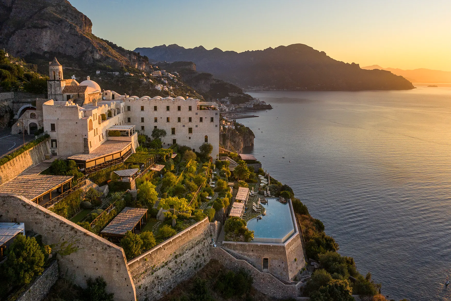 Europe, Italy, Amalfi Coast, Monastero Santa Rosa, view over the top of the hotel, pool and grounds at sunset