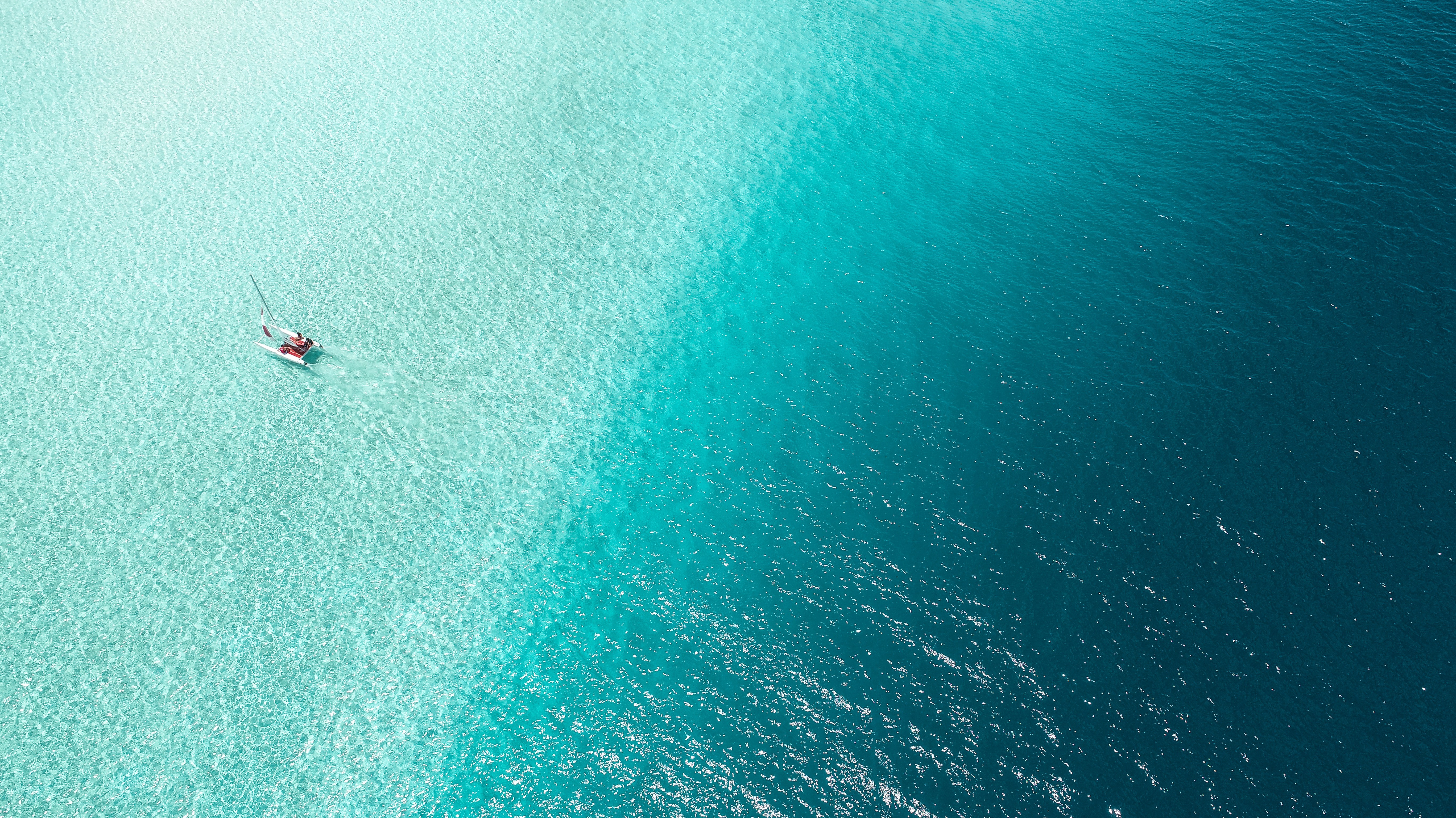 Aerial view of a small boat on clear sea water