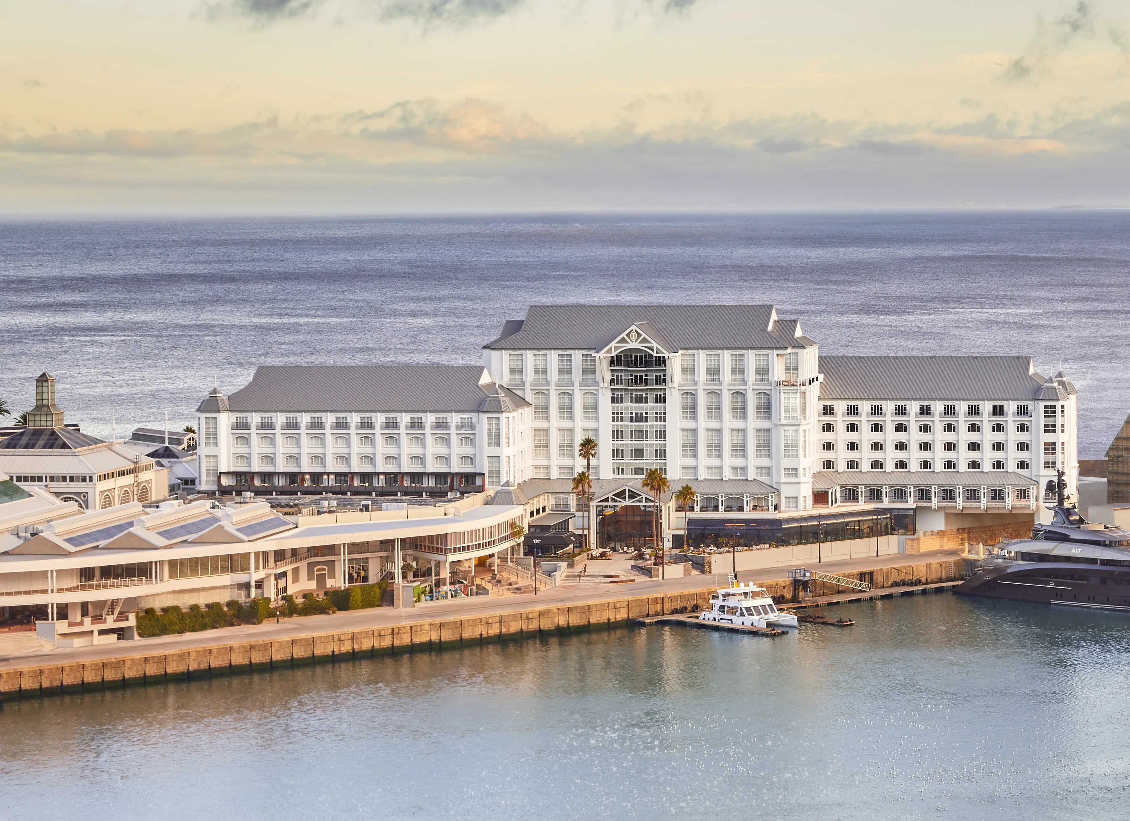 The exterior of InterContinental Table Bay on the water in front and the Victoria Shopping Centre to the left