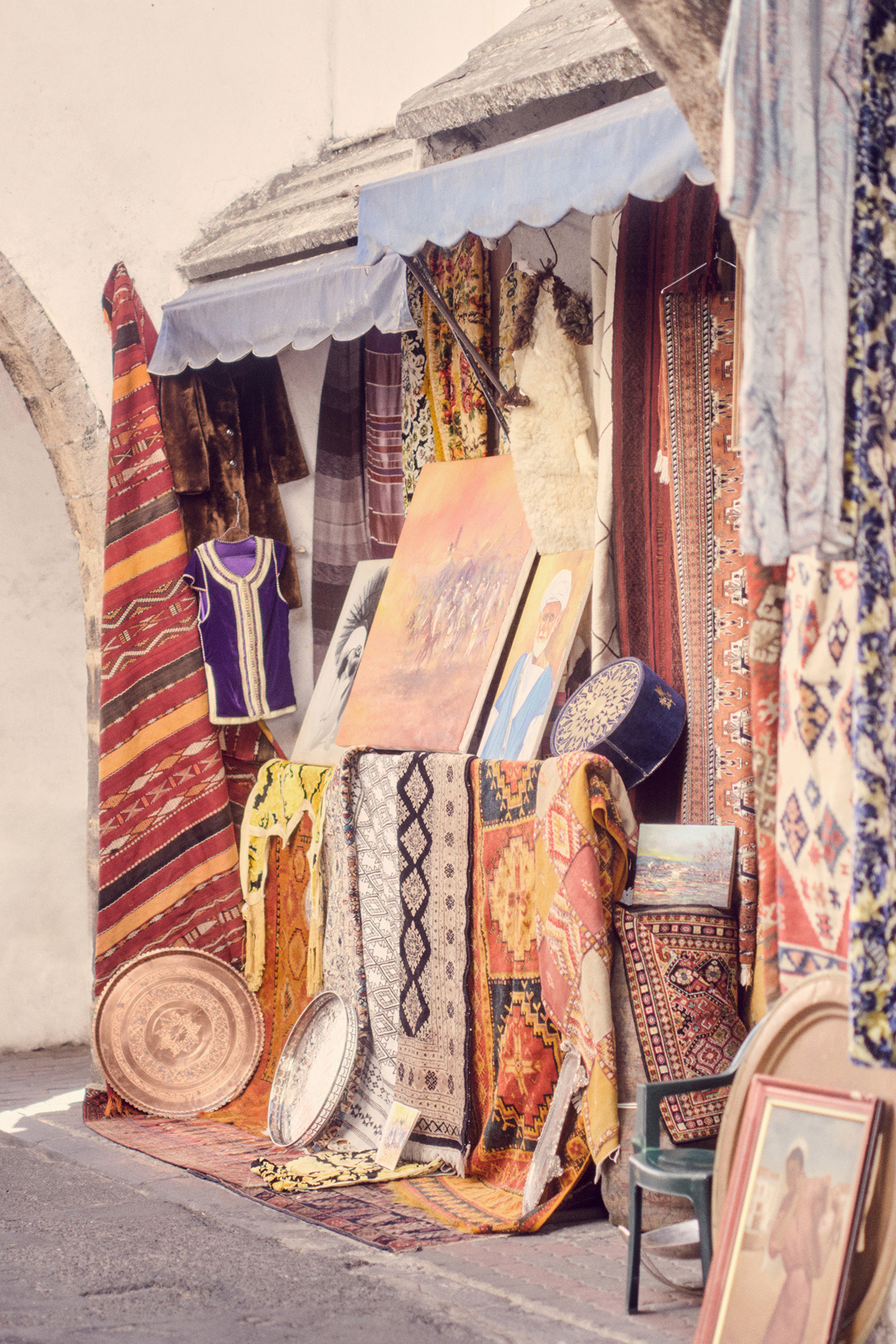 A street in Casablanca featuring a shop with multicoloured textiles outside