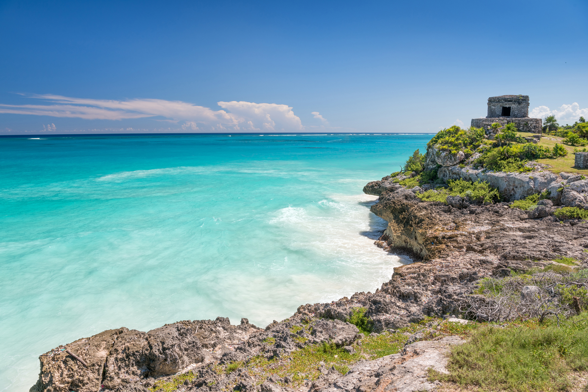 A rock coastline with a small stone structure in Mexico