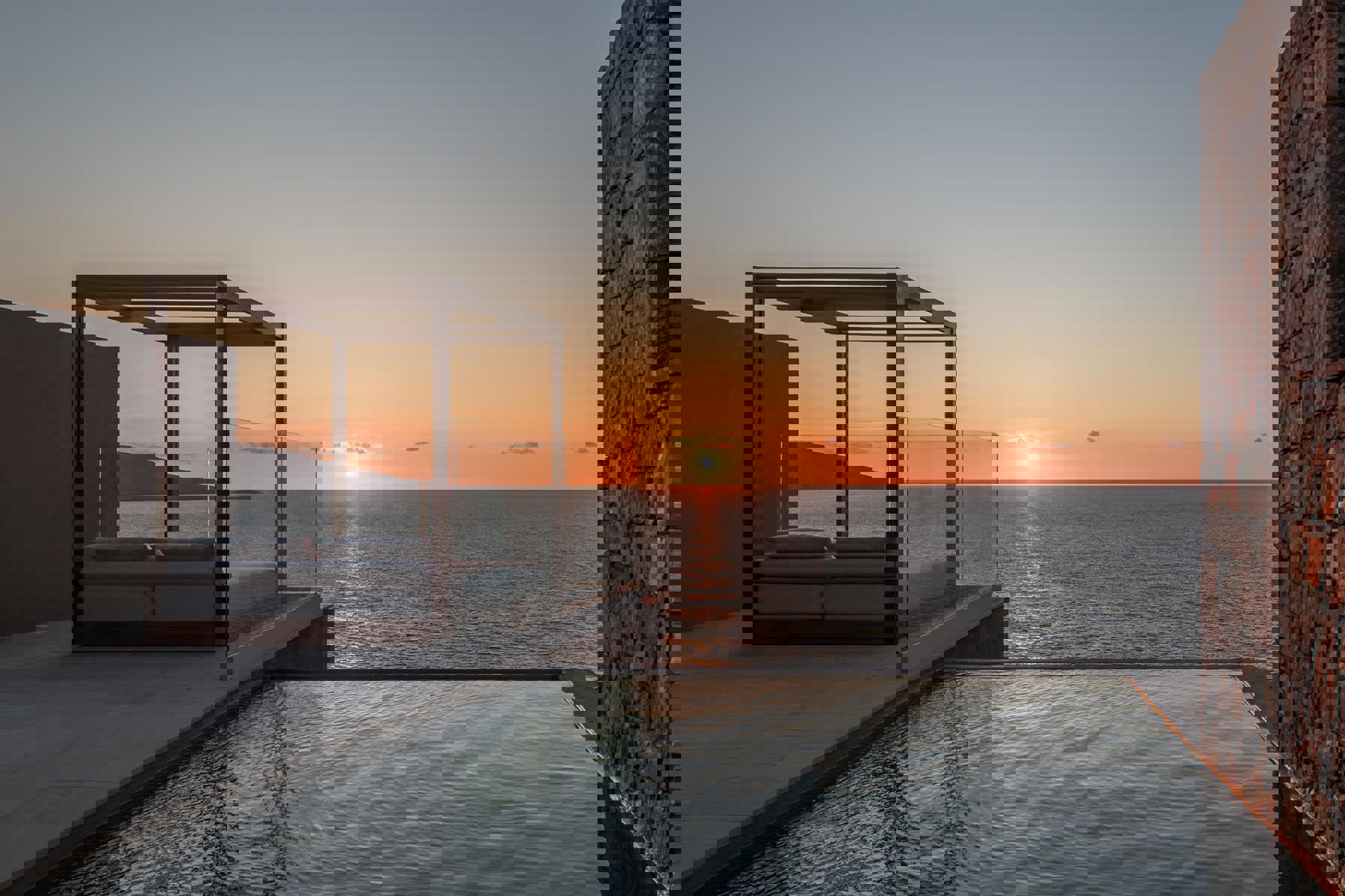 Lounger and private pool facing the sunset at Acro Wellness Suites