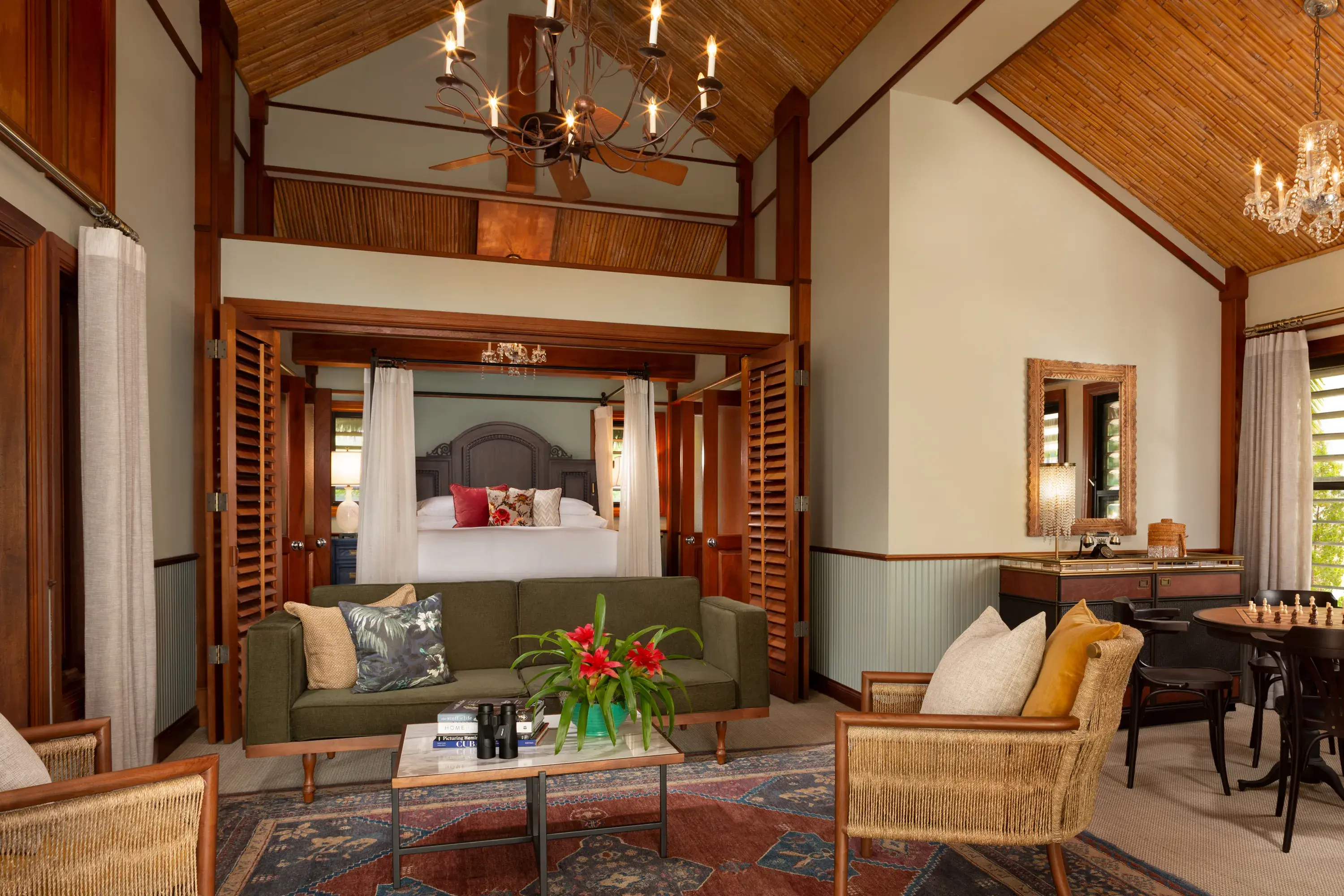 Spacious Island Grand suite at Little Palm Island Resort in Florida featuring canopy bed, vaulted ceiling, and elegant tropical decor.