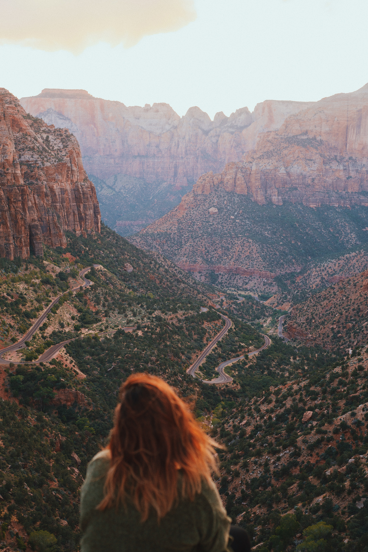 A woman looking out towards a brown mountain range