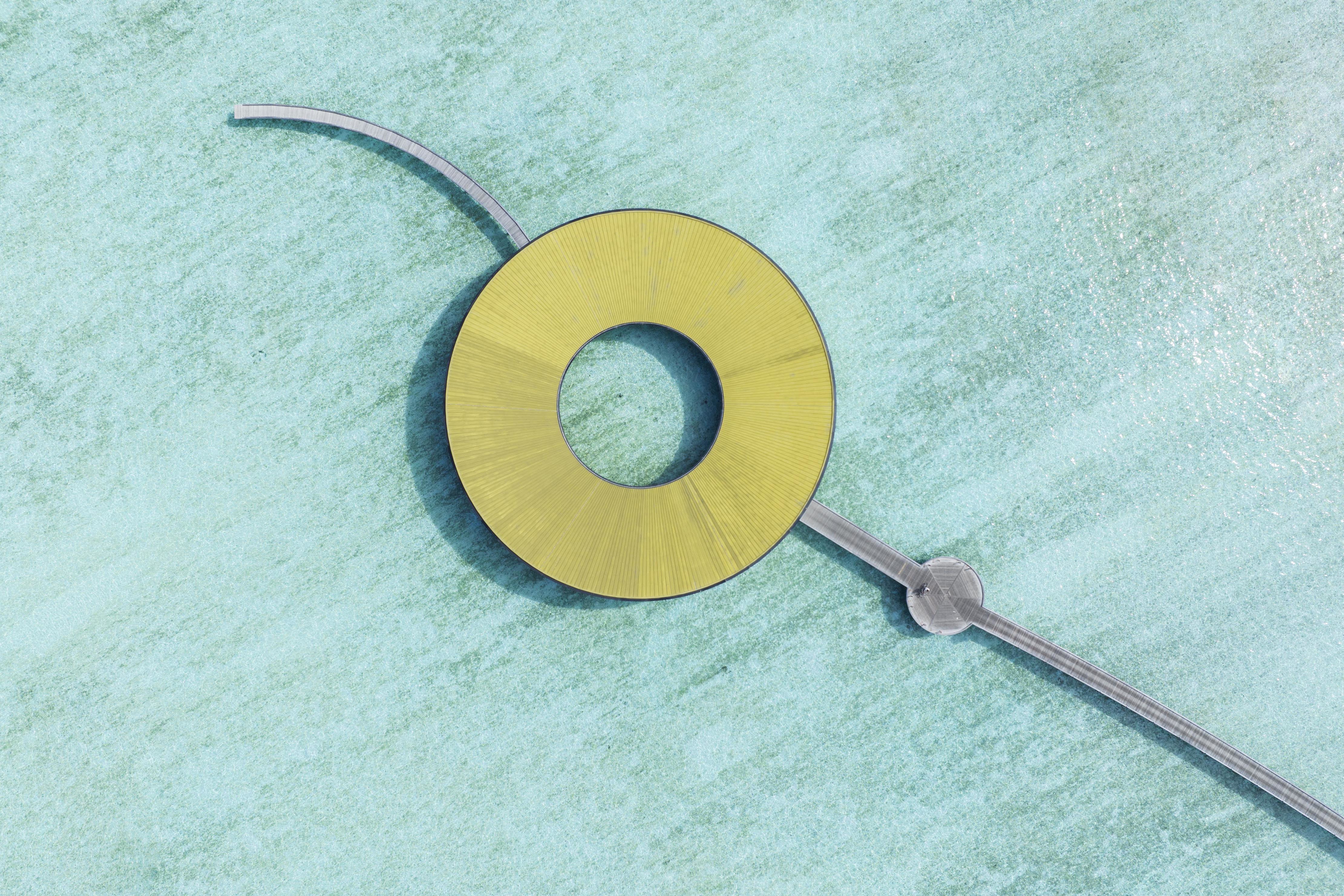 Aerial view of the circular spa of Ritz Carlton Fari Islands in the middle of the blue ocean