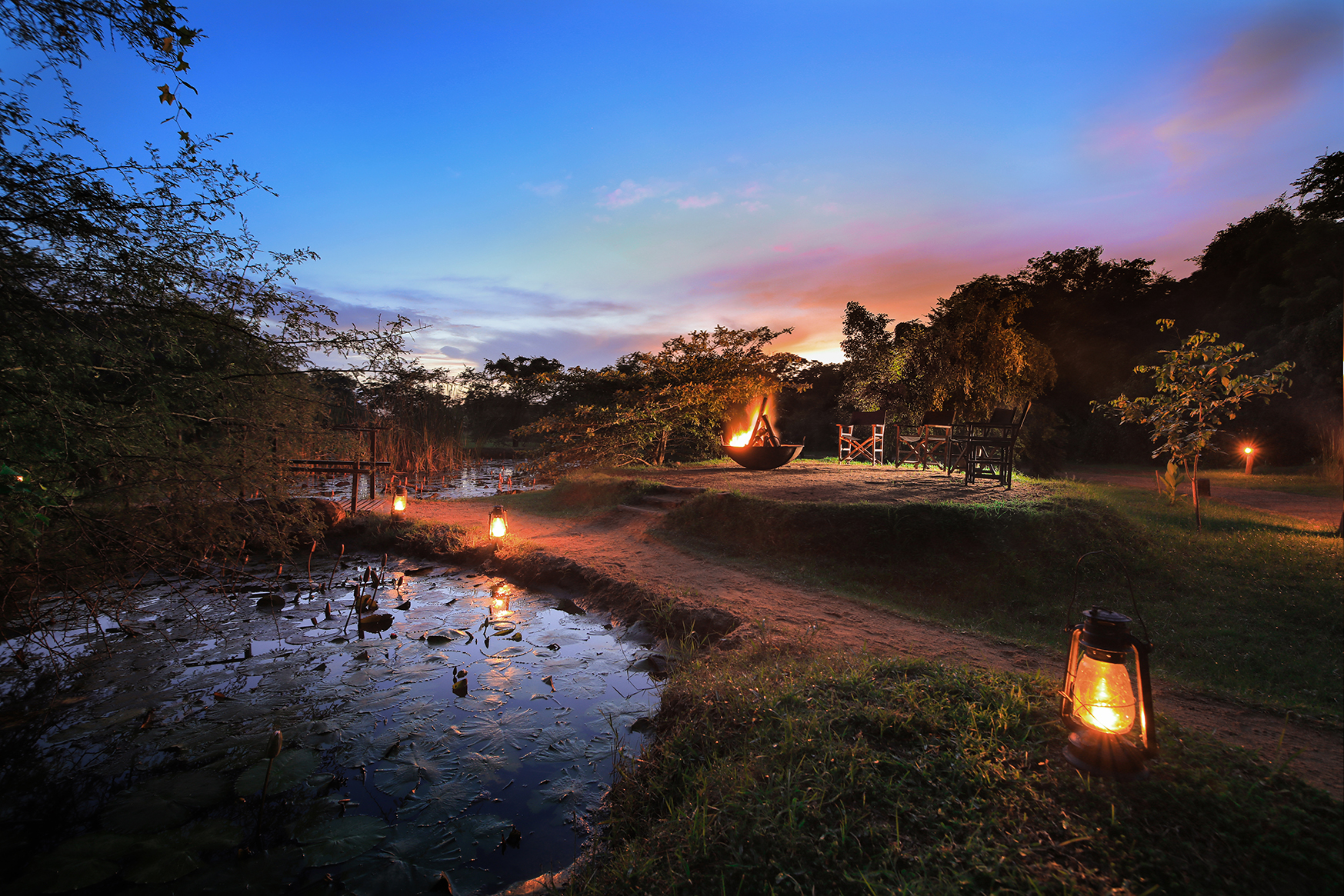 Asia, Sri Lanka, Leopard Trails Camps, view of seating around a firepit at night 
