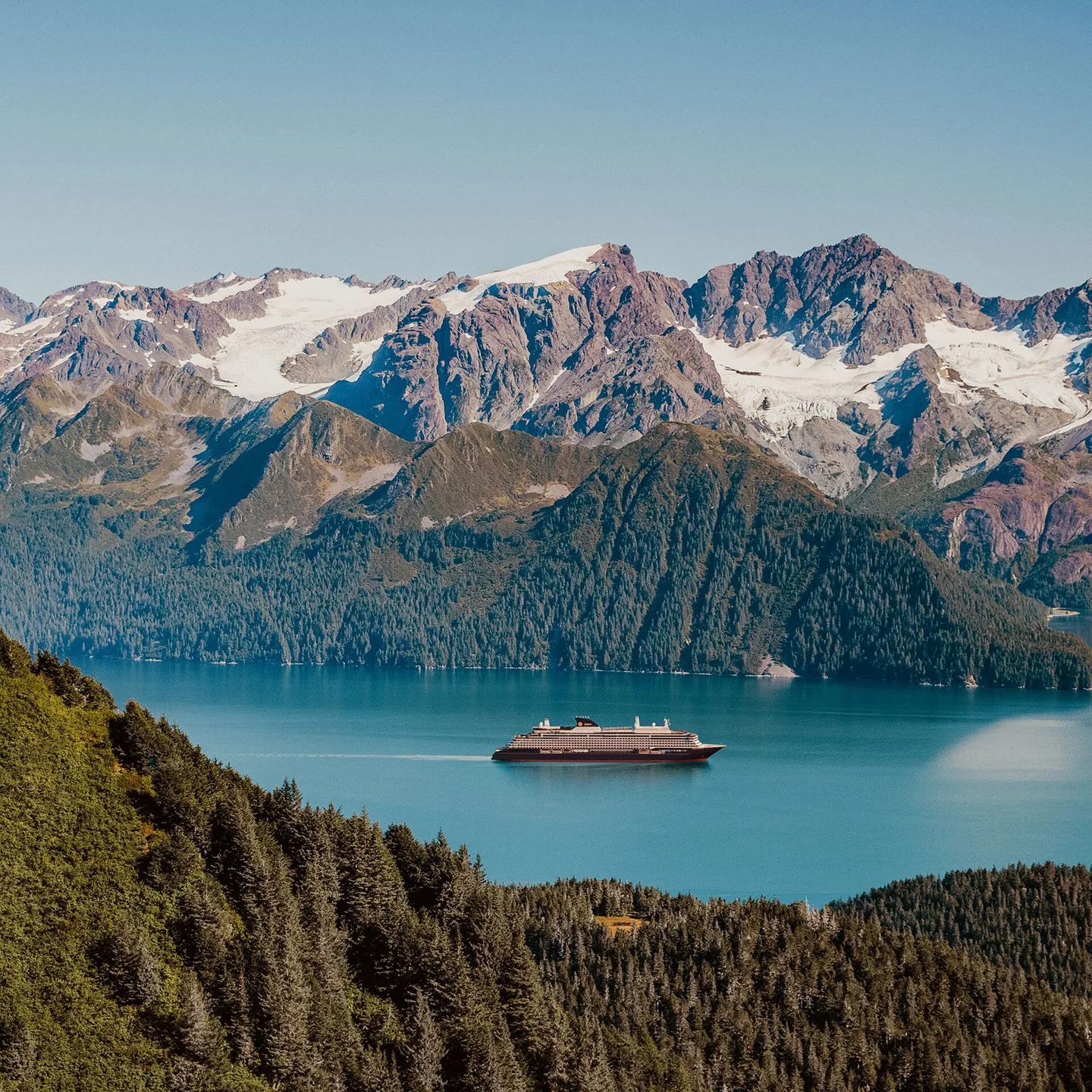 Cruise, Explora Journeys, Explora III cruise ship sailing in front of snow-capped mountains