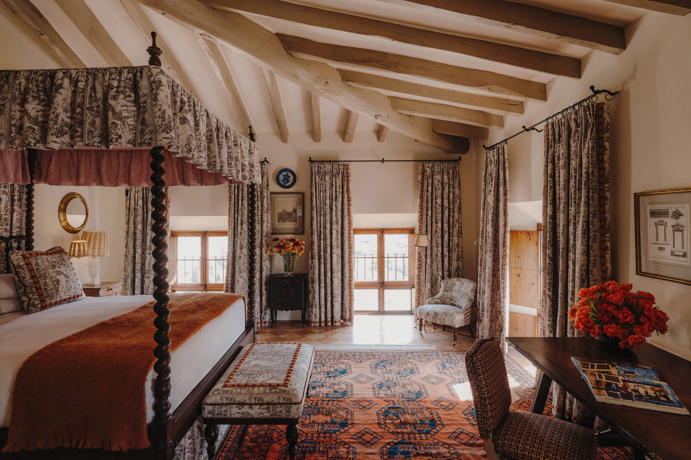 Four poster bed and desk area of Galilea Junior Suite at Son Net