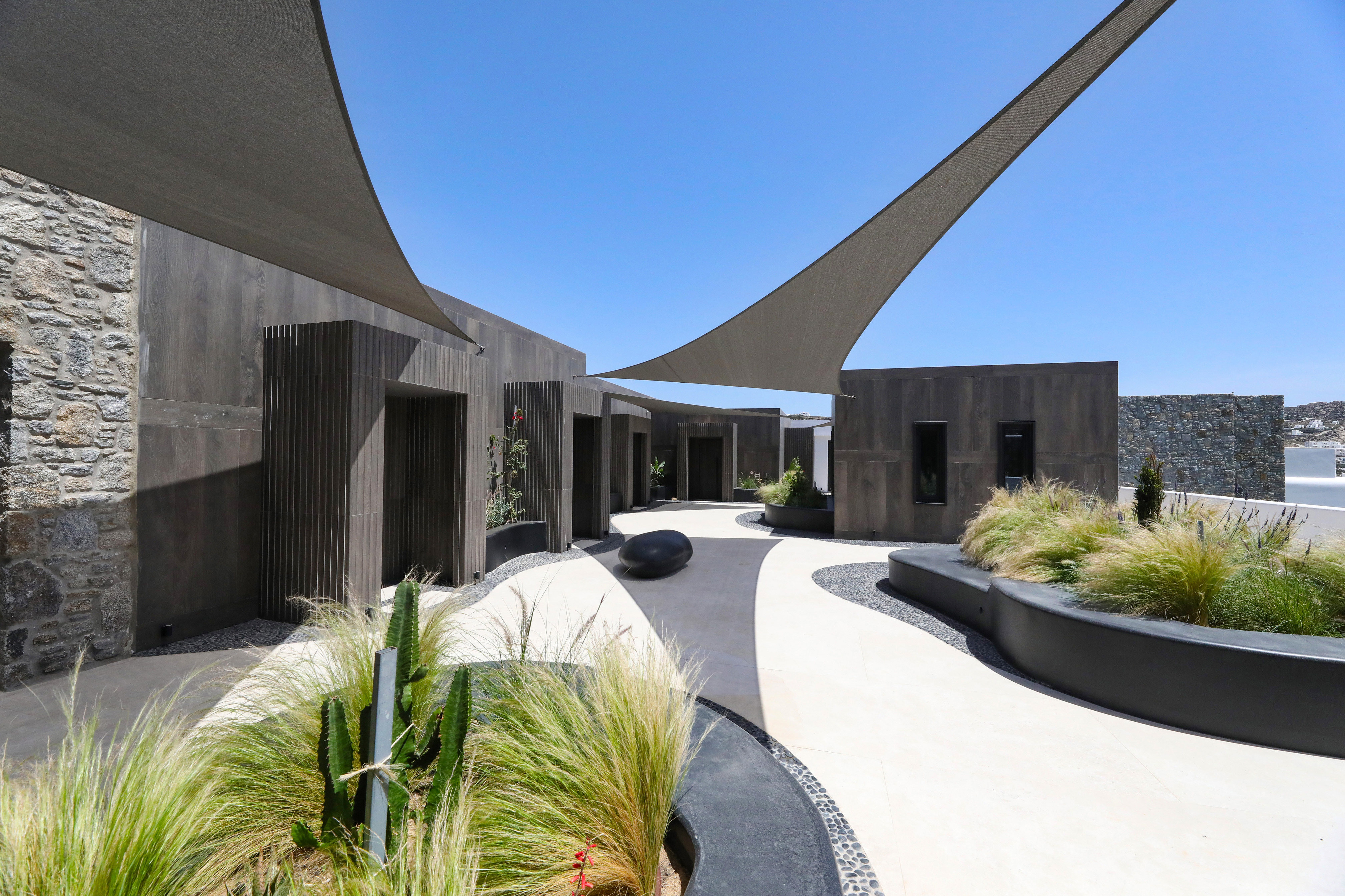 Treatment room doors in the courtyard of the spa at Aeonic Suites & Spa 