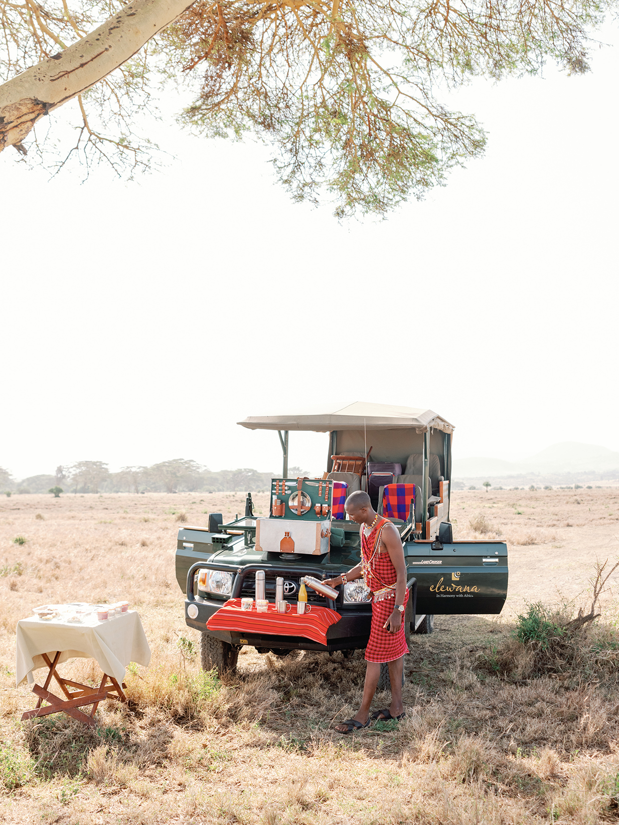 Africa, Kenya, Elewana Kifaru House Bush Breakfast served on the bonnet of a game drive vehicle