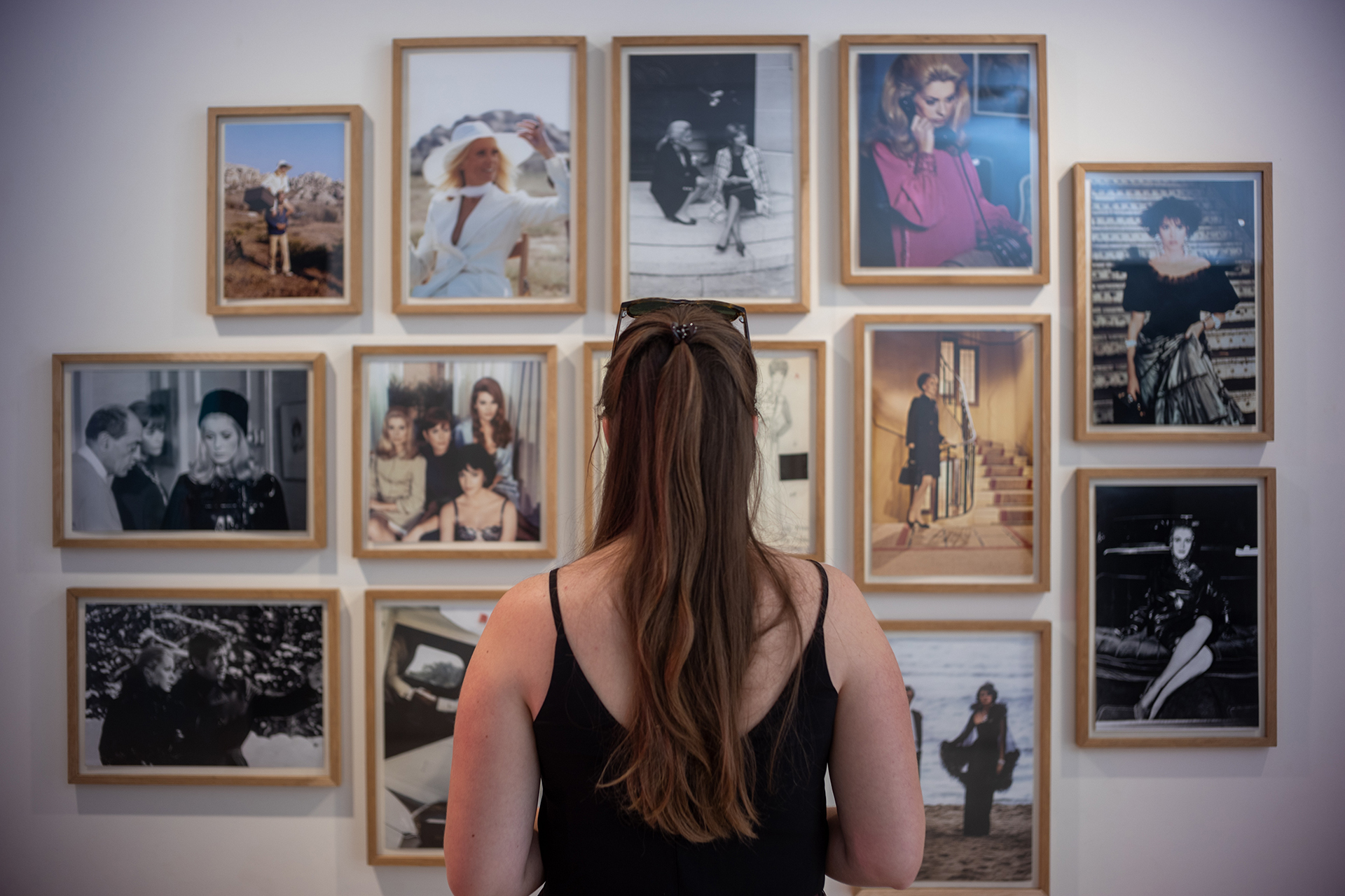 A woman looking at framed photos in Moroccan museum