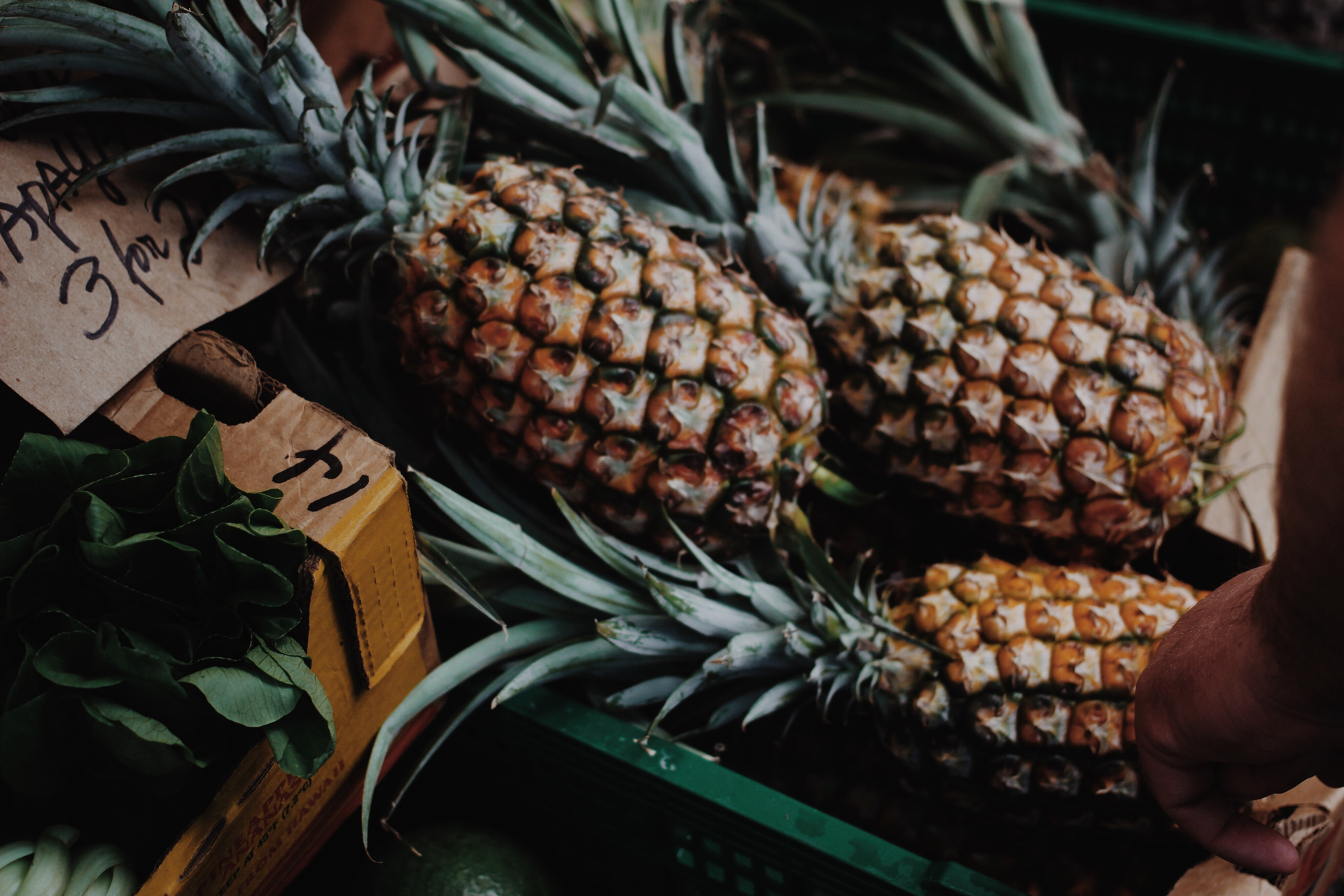 Pineapple fruit on a green plastic crate