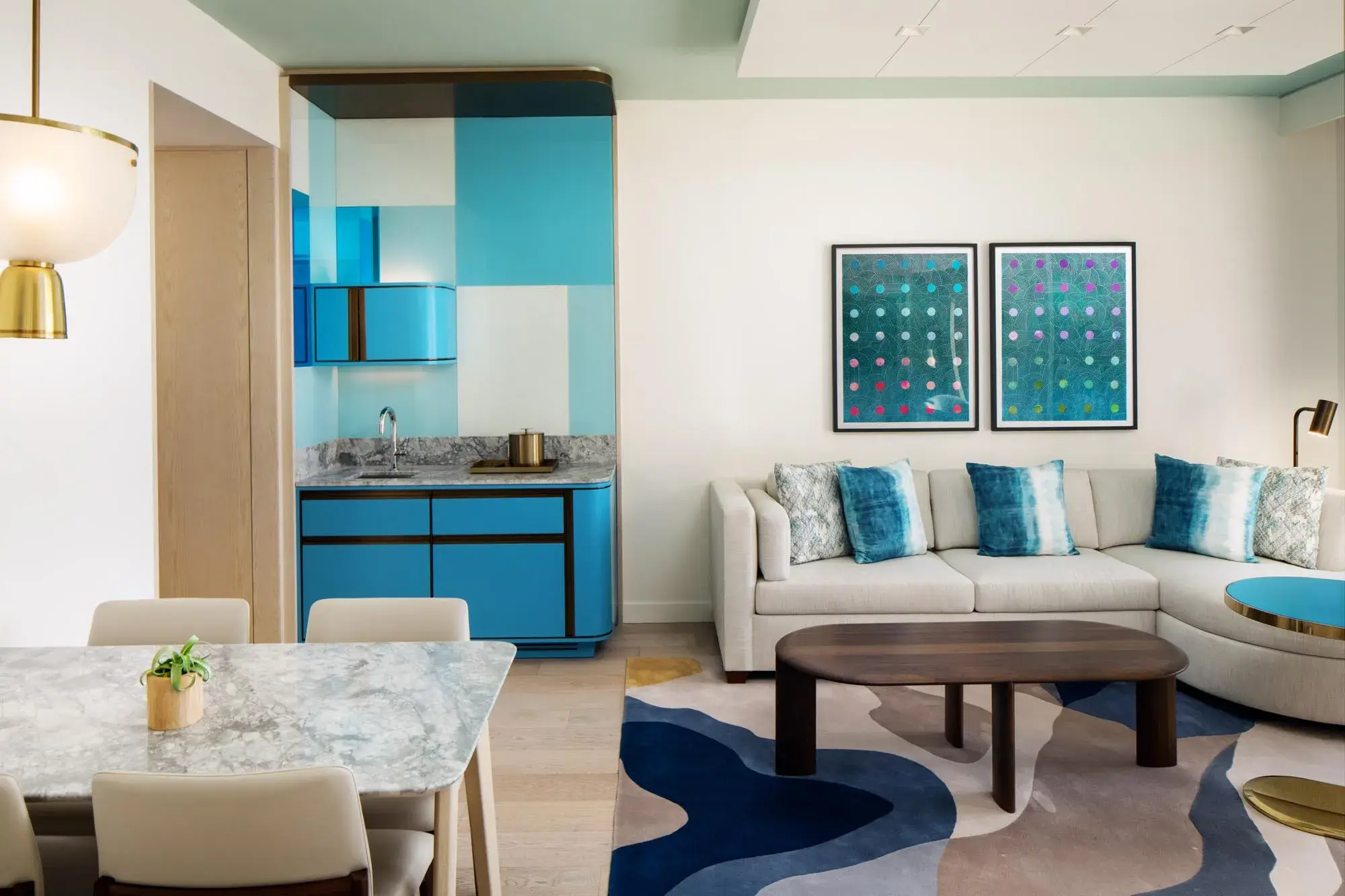Modern luxury Suite at Conrad Orlando in Florida featuring contemporary décor, a spacious seating area, and stylish blue accents.