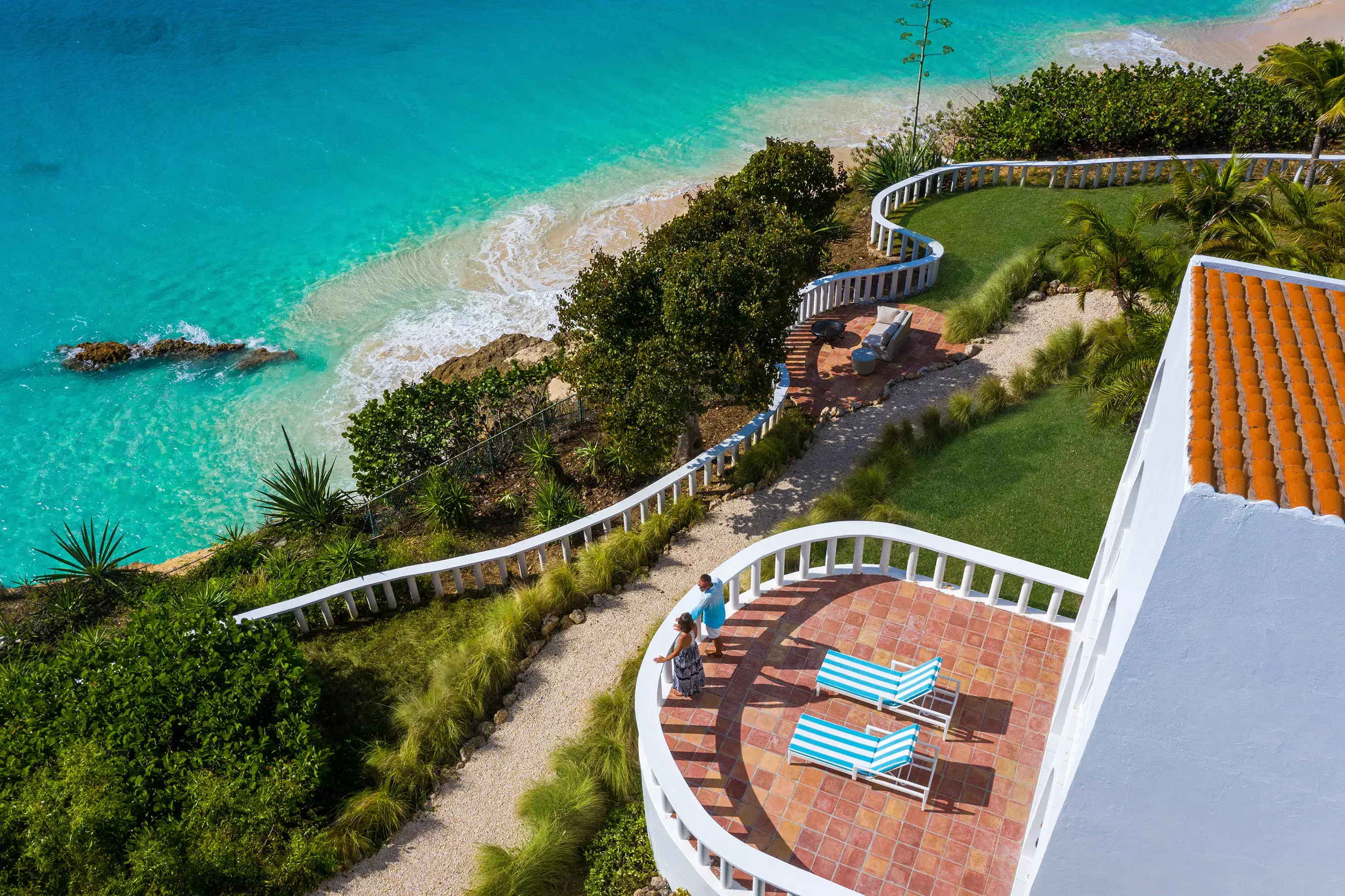 Oceanfront four-bedroom villa at Malliouhana, Anguilla, featuring a private terrace, lush tropical gardens, and breathtaking views of turquoise Caribbean waters.