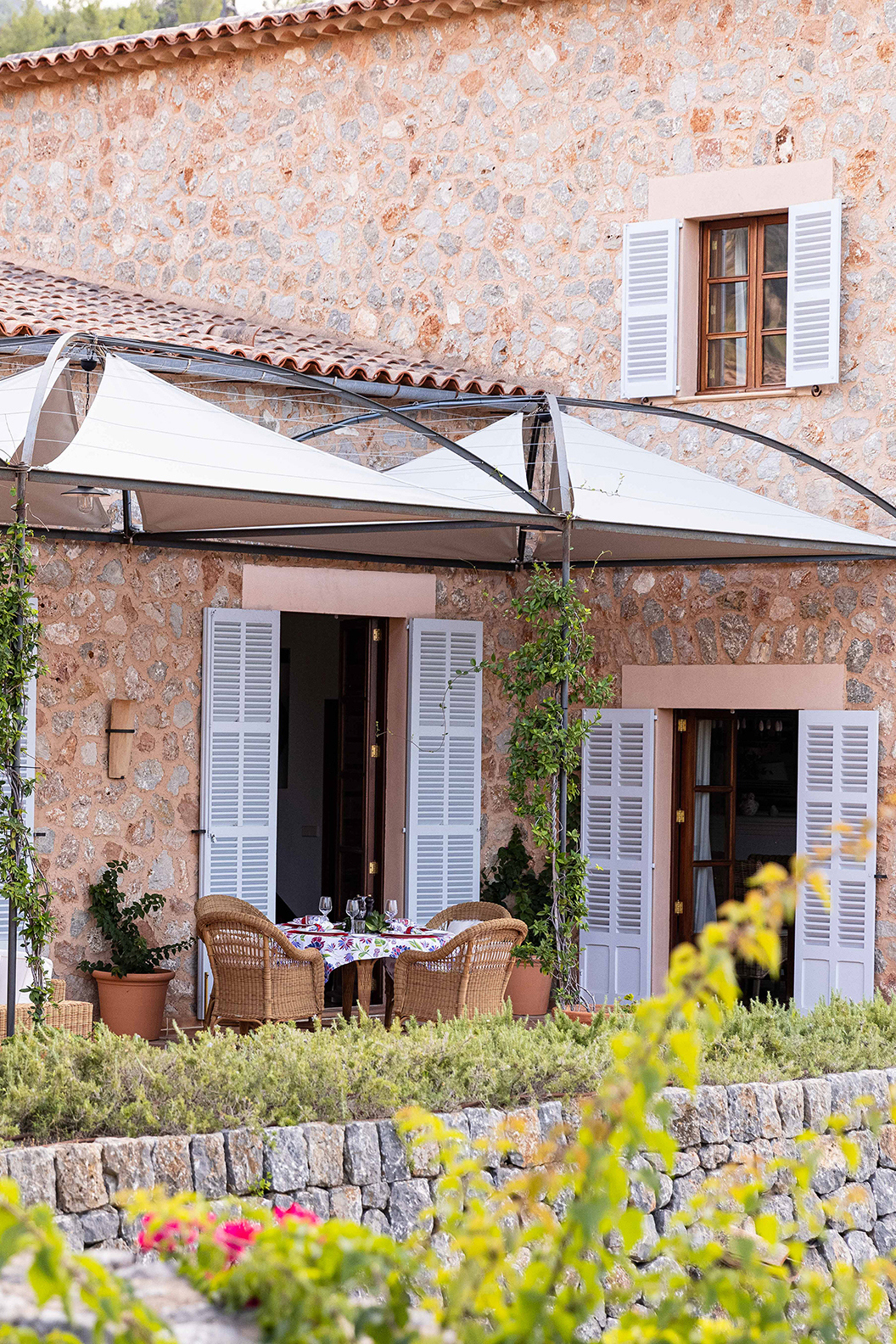 Villa outdoor lounge area with rattan seating and foliage 