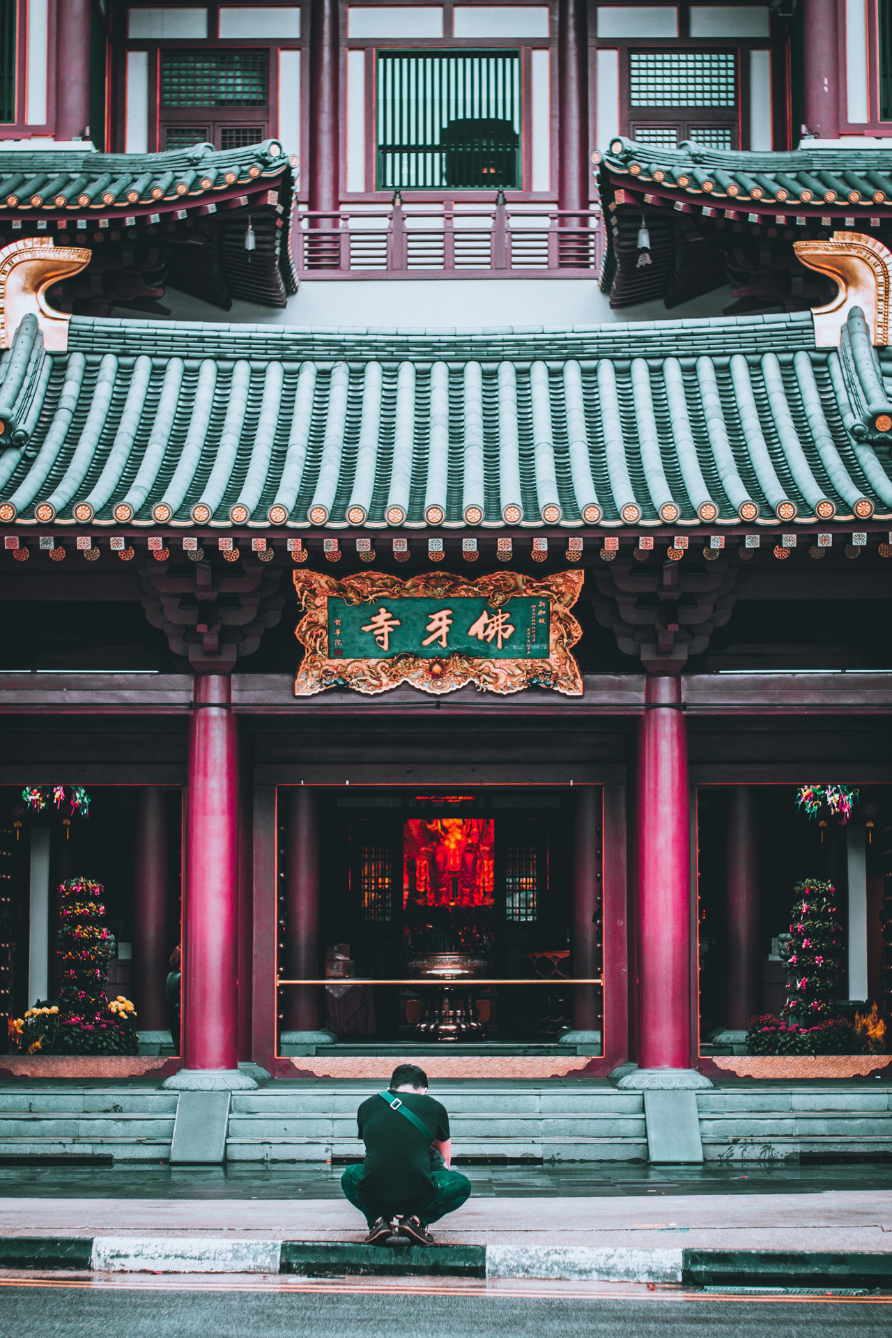a person crouching in front of a temple building