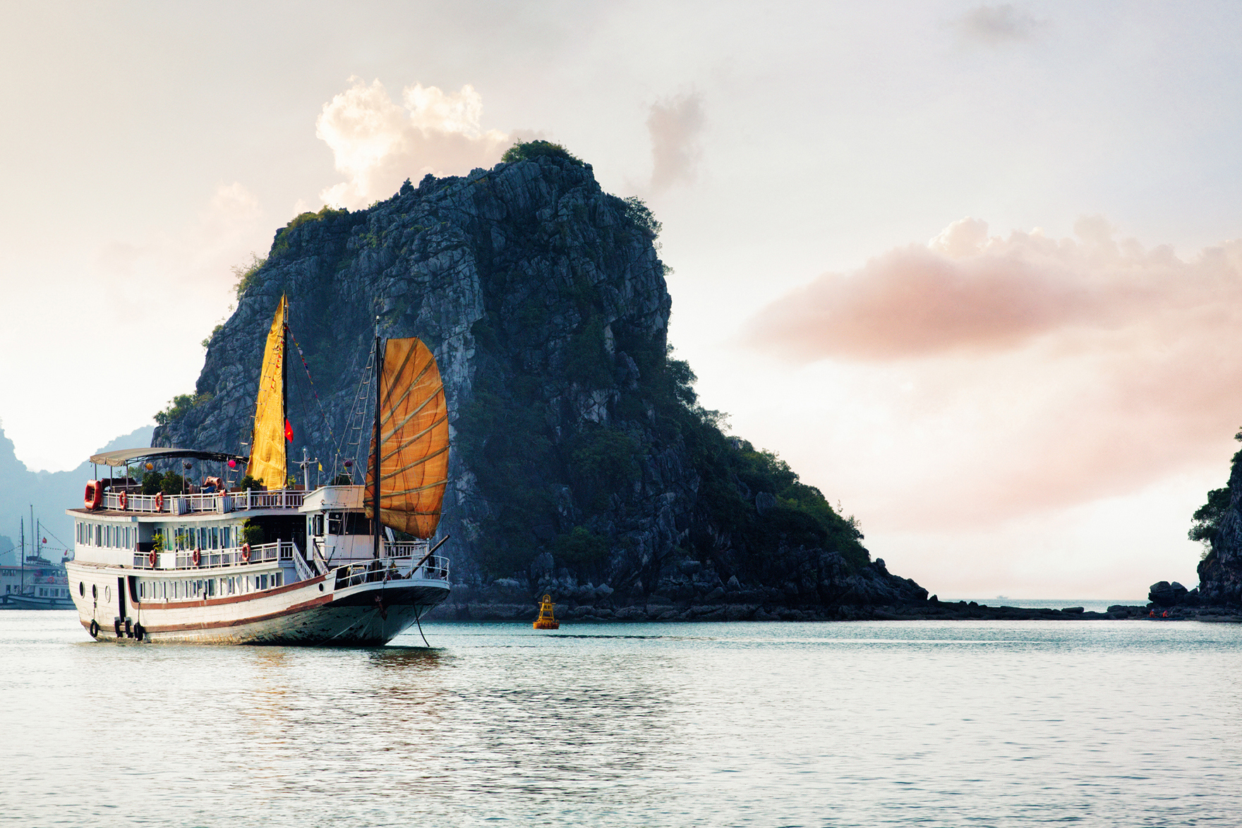 Traditional junk boat anchored in Halong Bay
