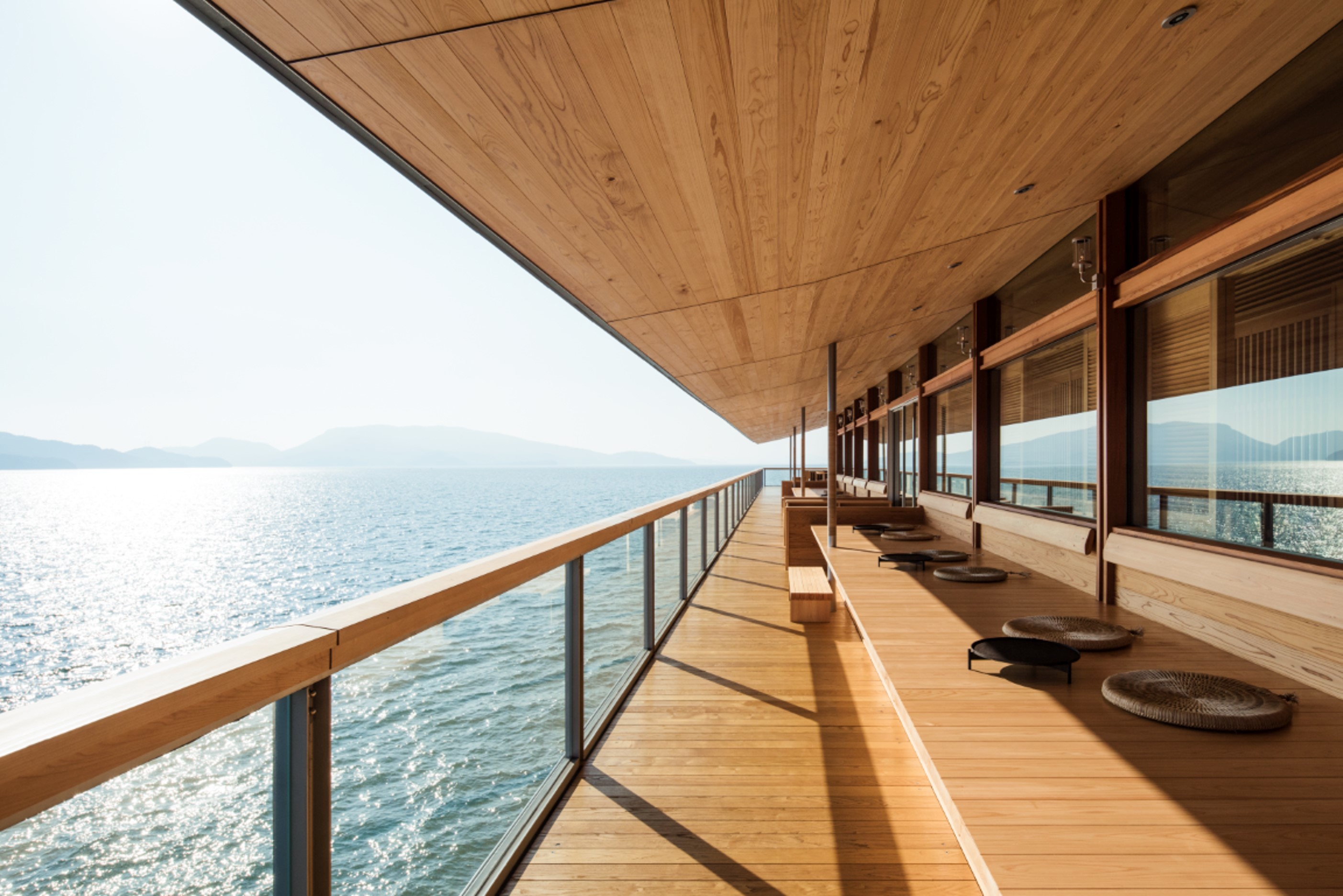 A traditional Engawa terrace with a hinoki bench partially lit but the sun