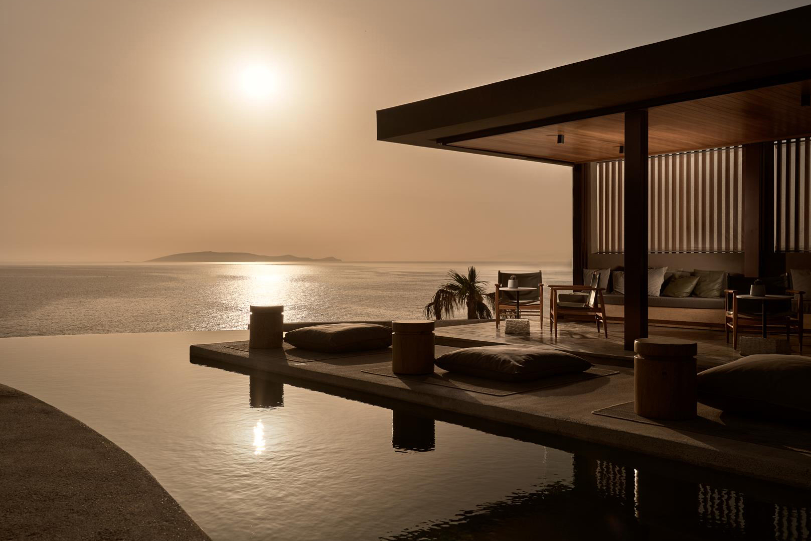 Pool and bar seats during sunset at Acro Wellness