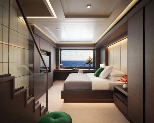 A luxurious bedroom with ocean views, green accent pillows, modern furnishings, and a staircase to an upper level.