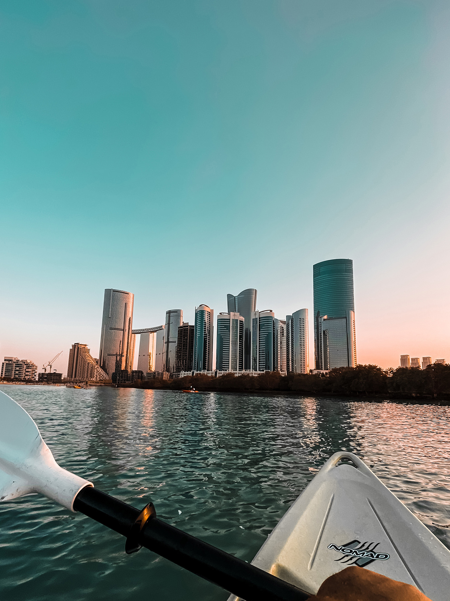 a city skyline seen from a canoe boat