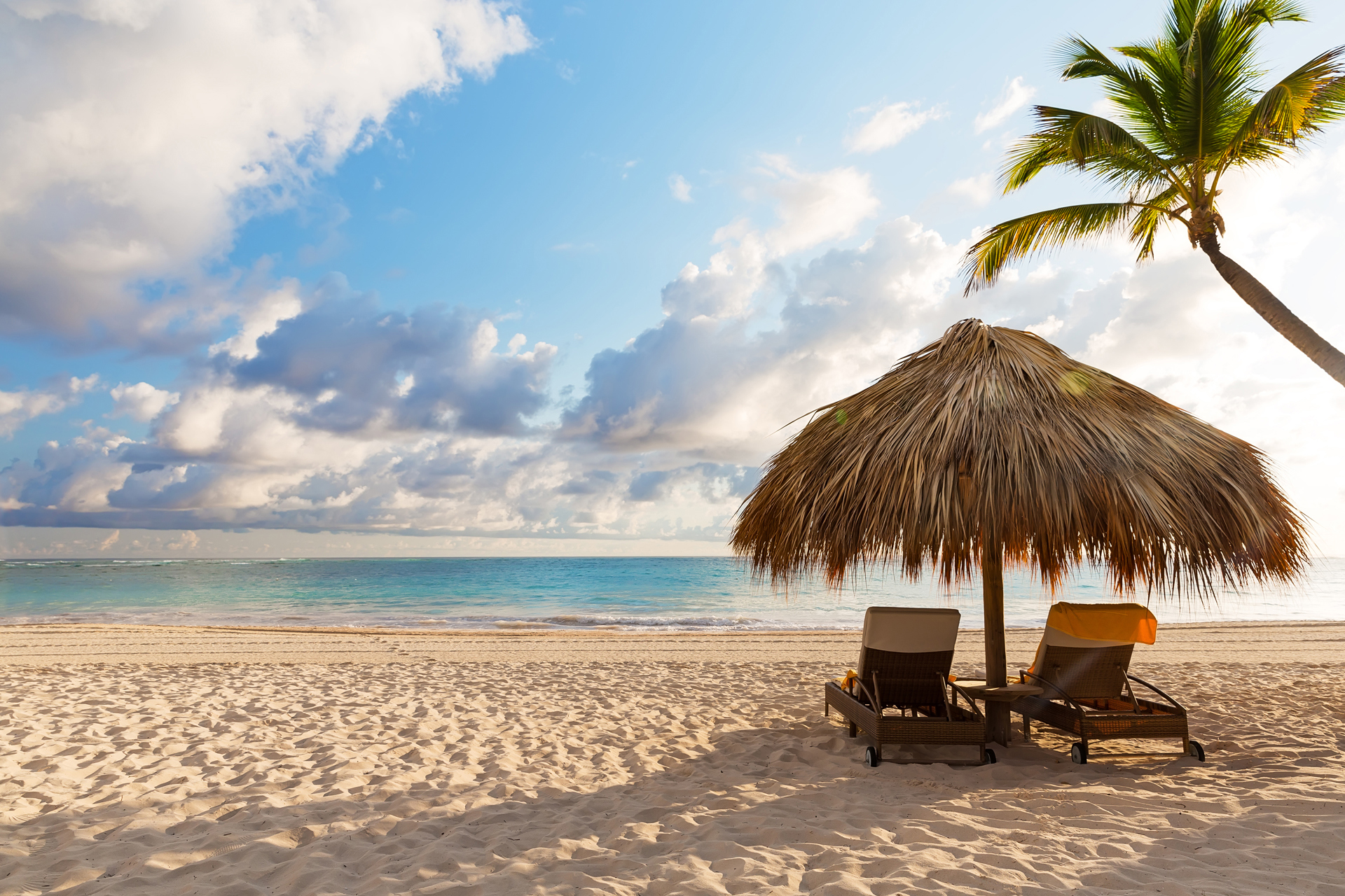 Two loungers under an umbrella on the beach