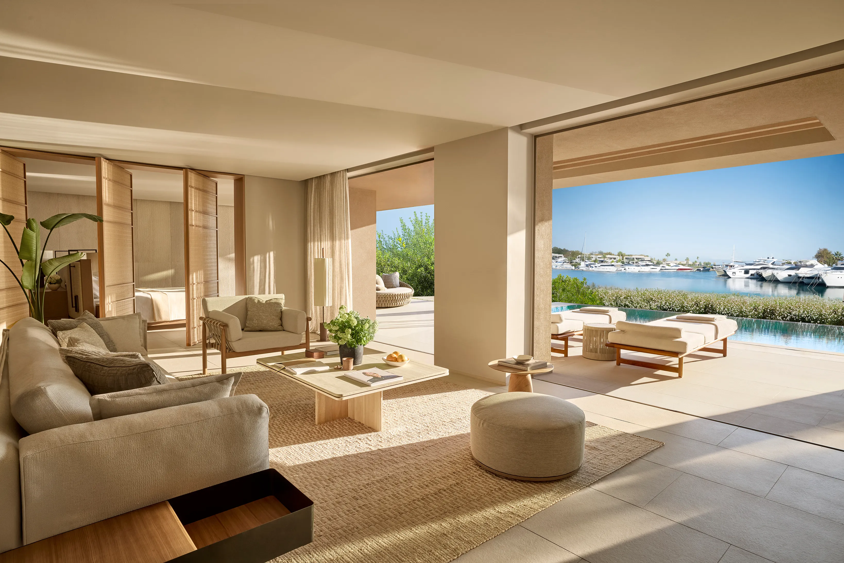 Spacious luxury two bedroom residence at Sani Asterias in Halkidiki featuring elegant open‑plan living and a private terrace with marina and pool views.