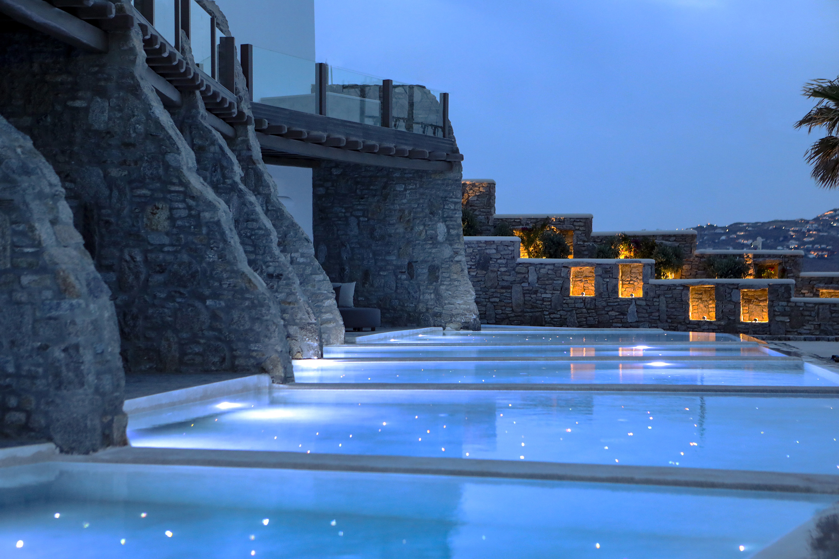 Pool suites lit up at night at Aeonic Suites & Spa