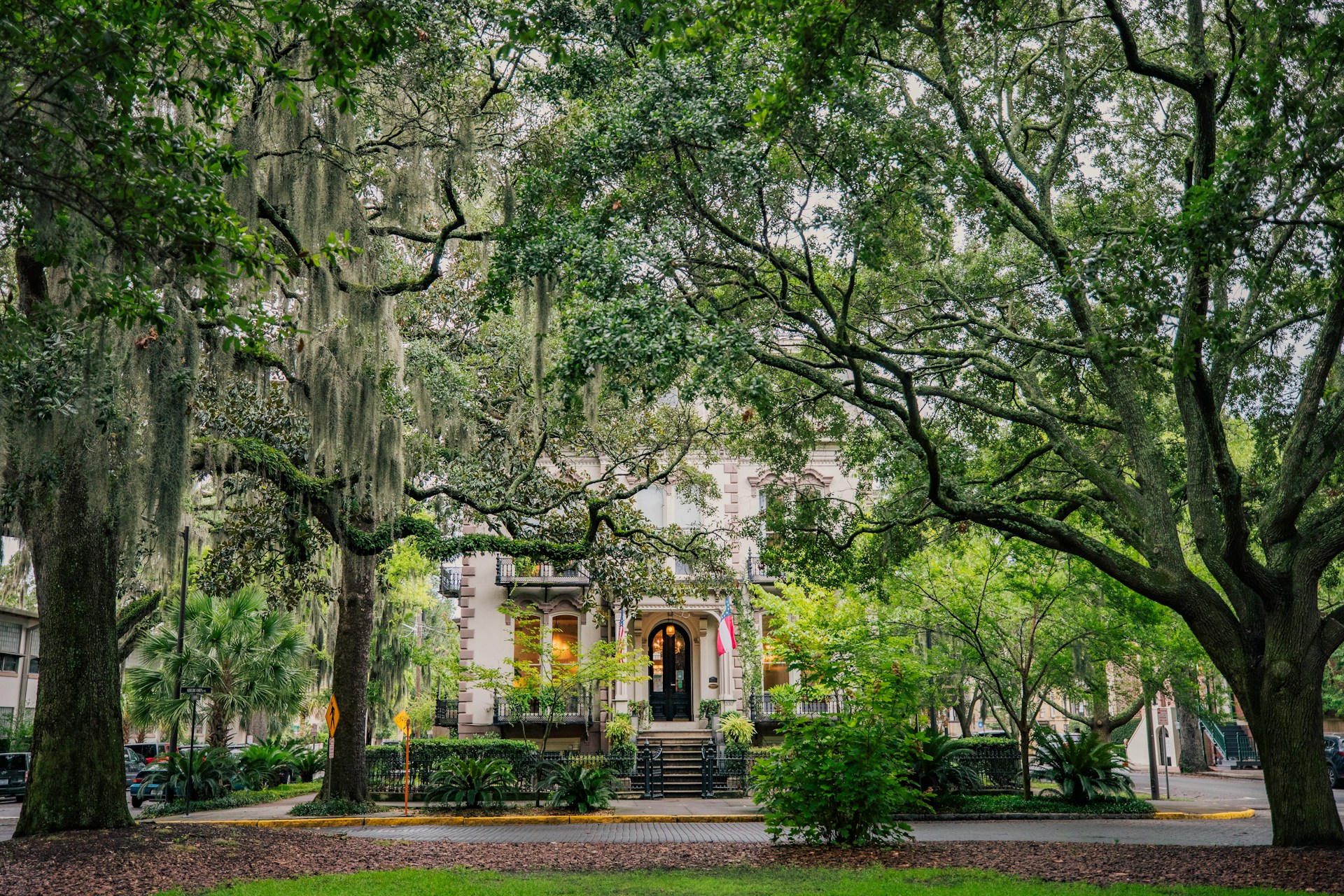 Historic townhouse framed by mature oak trees and Spanish moss in Savannah, Georgia