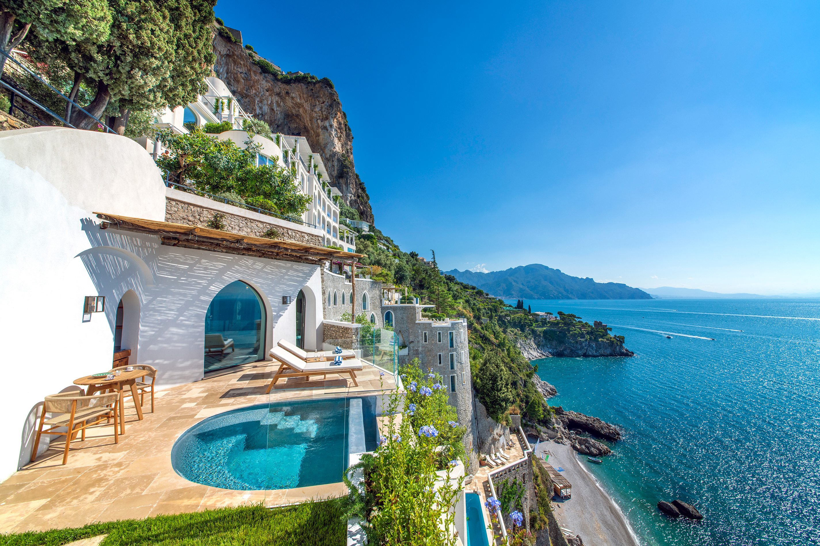 Andrea Suite at Borgo Santandrea in Amalfi featuring a private pool, lush greenery, and panoramic views of the Mediterranean Sea.