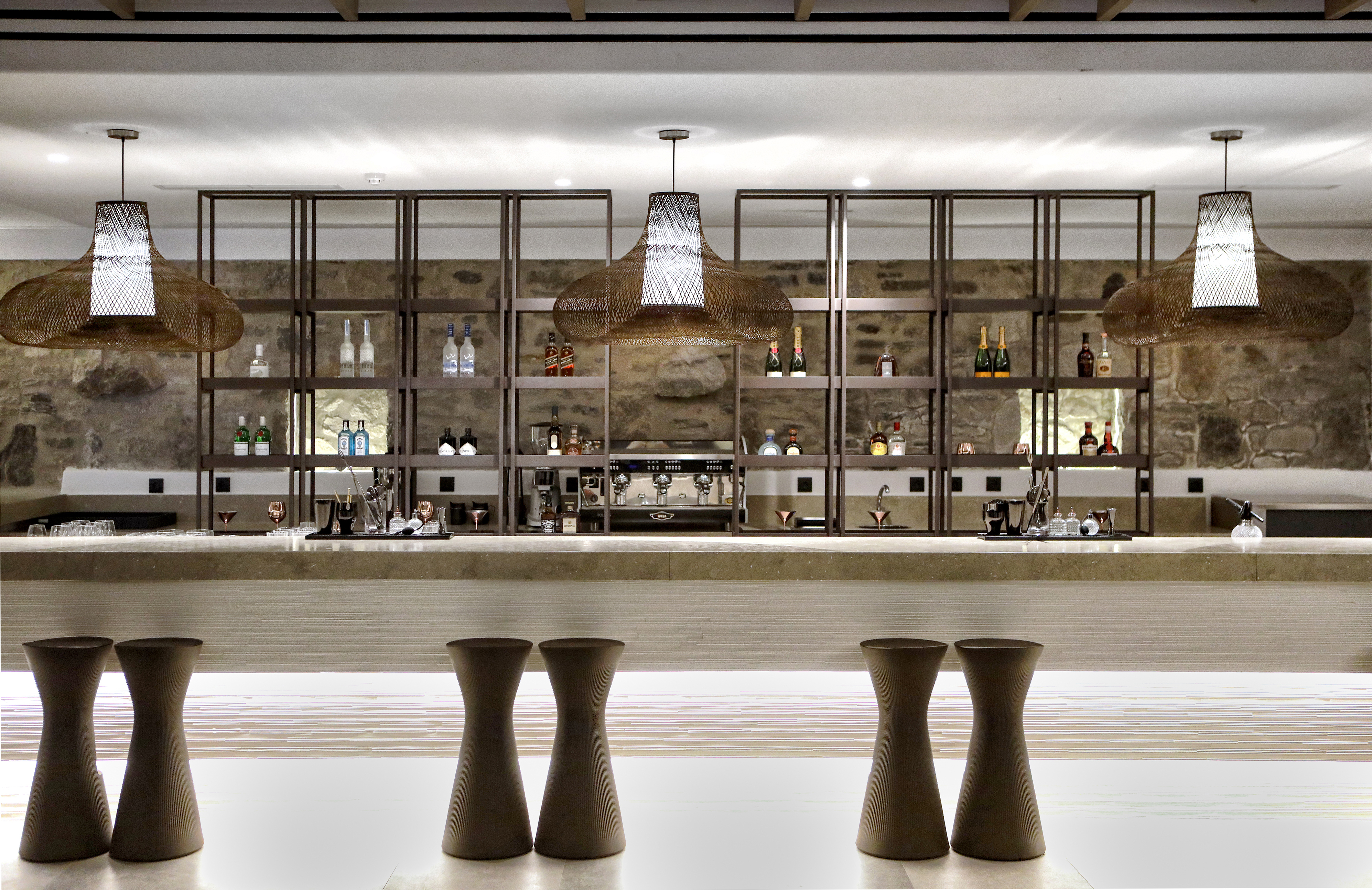 Stools and drinks in the bar at Aeonic Suites & Spa