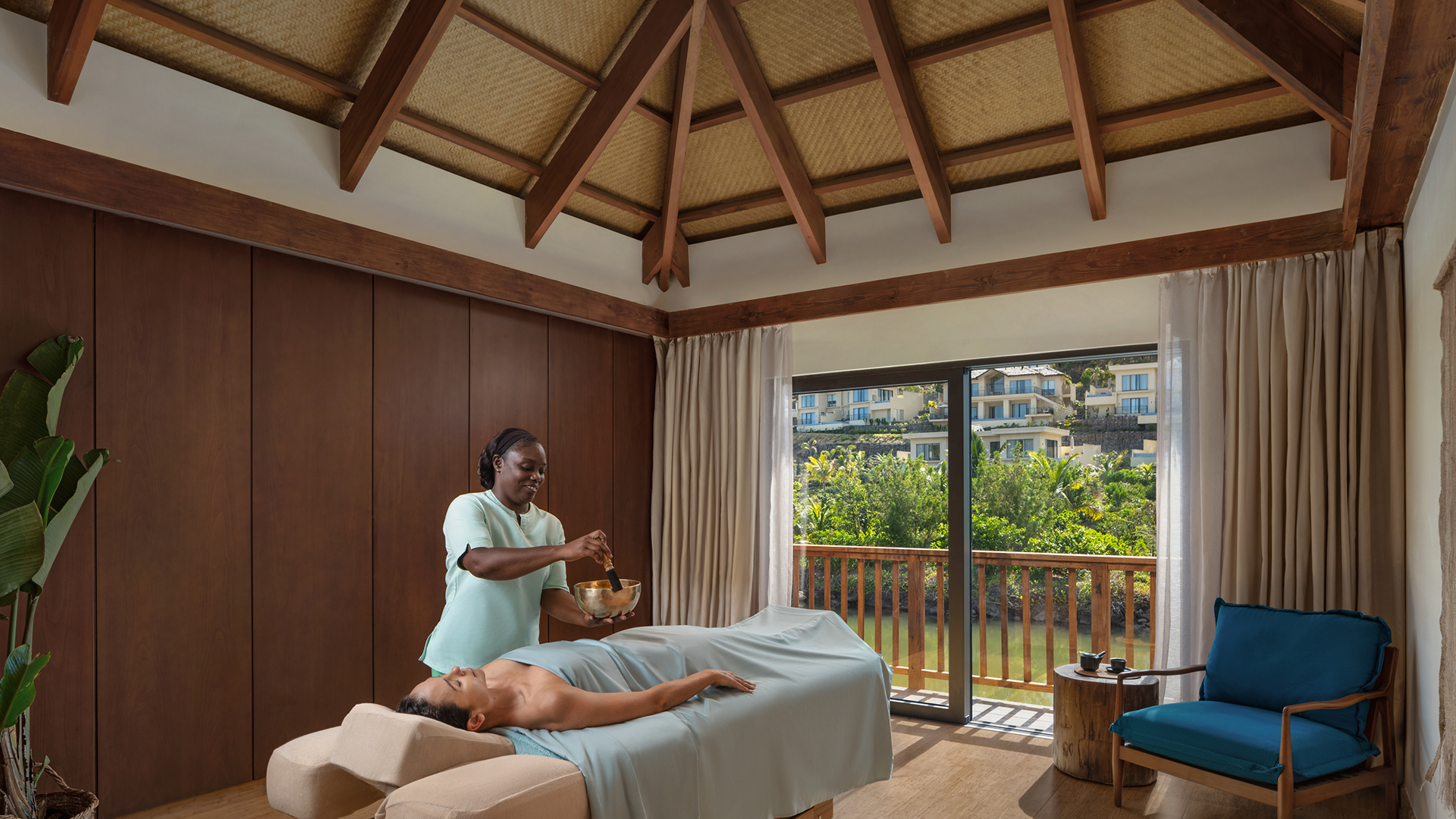 Caribbean & Mexico, woman having a massage and sound bath in A treatment room at Six Senses La Sagesse, Grenada