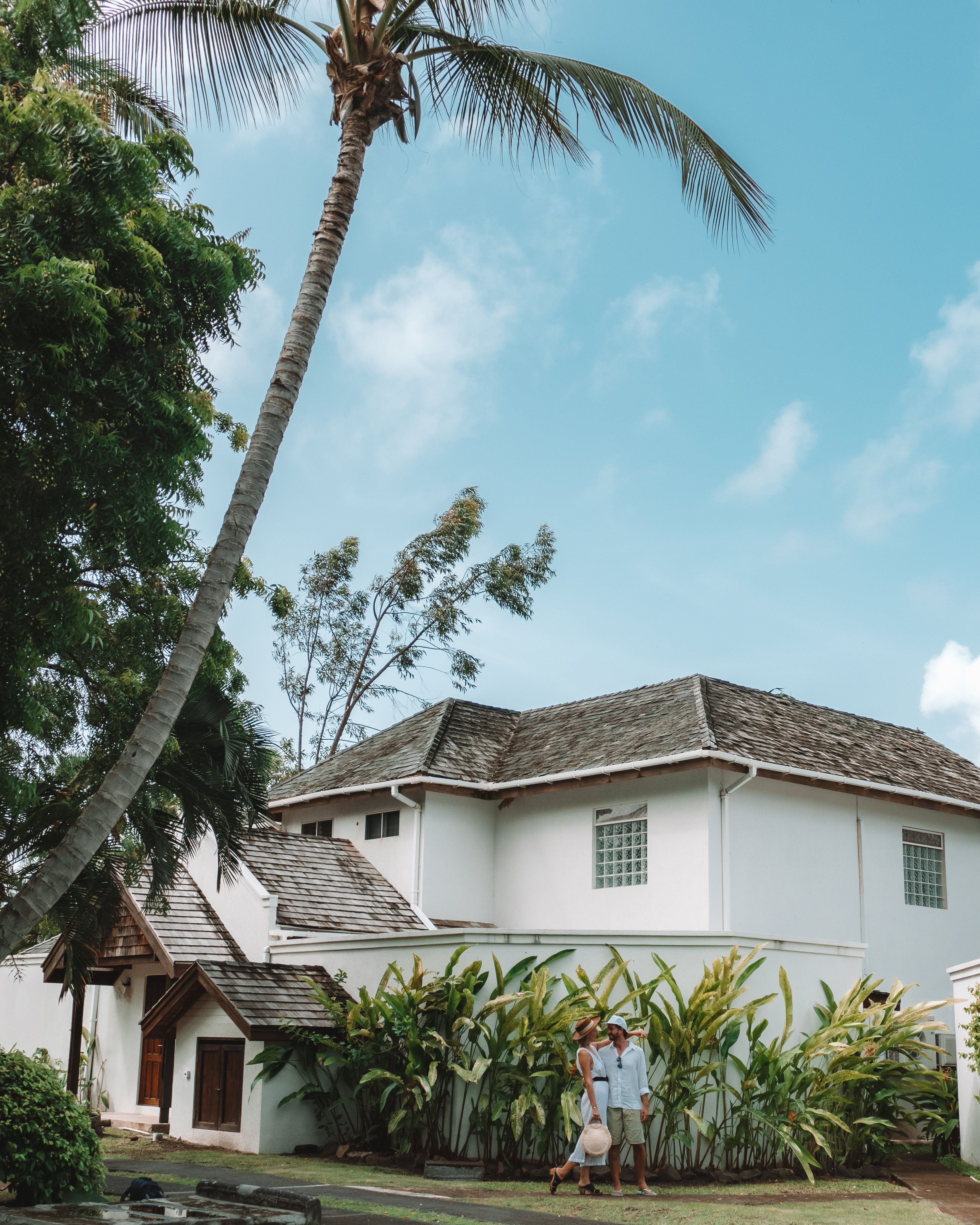 Two people stood by a white building