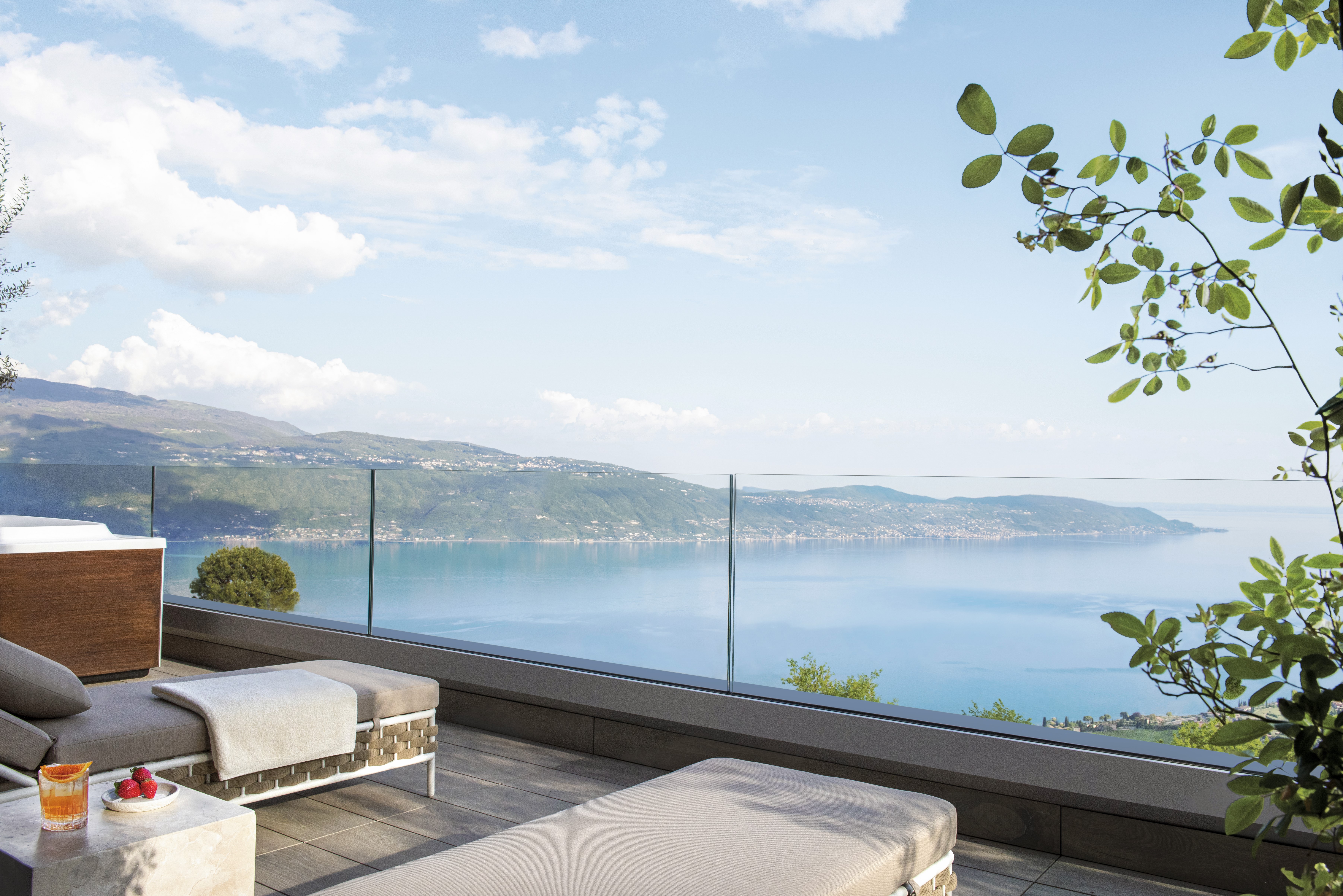 Europe, Italy, Lefay Resort & SPA Lago di Garda, sun loungers on a sky suite terrace overlooking Lake Garda 