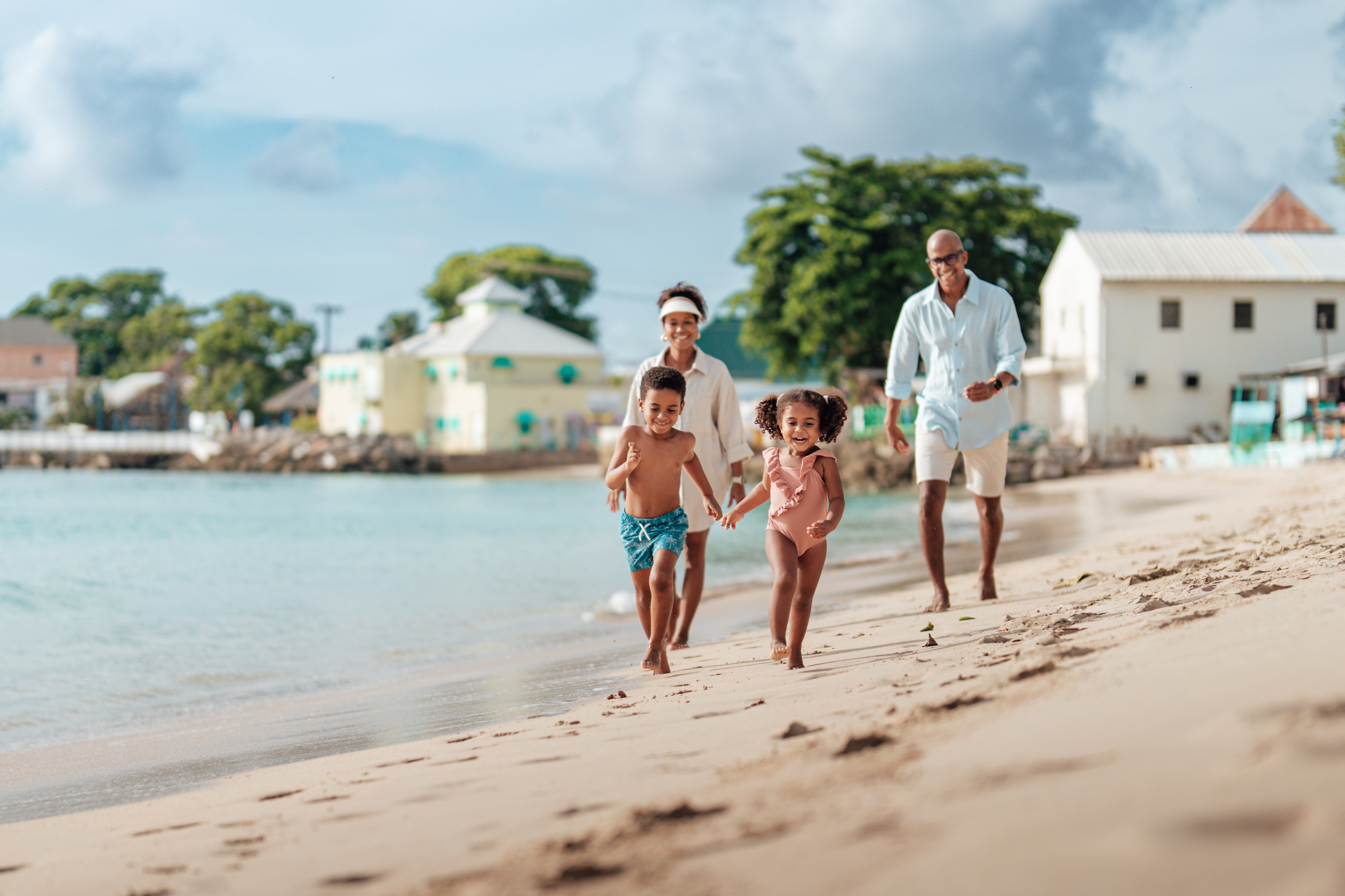 Caribbean, Barbados, Apes Hill, Family running along the beach