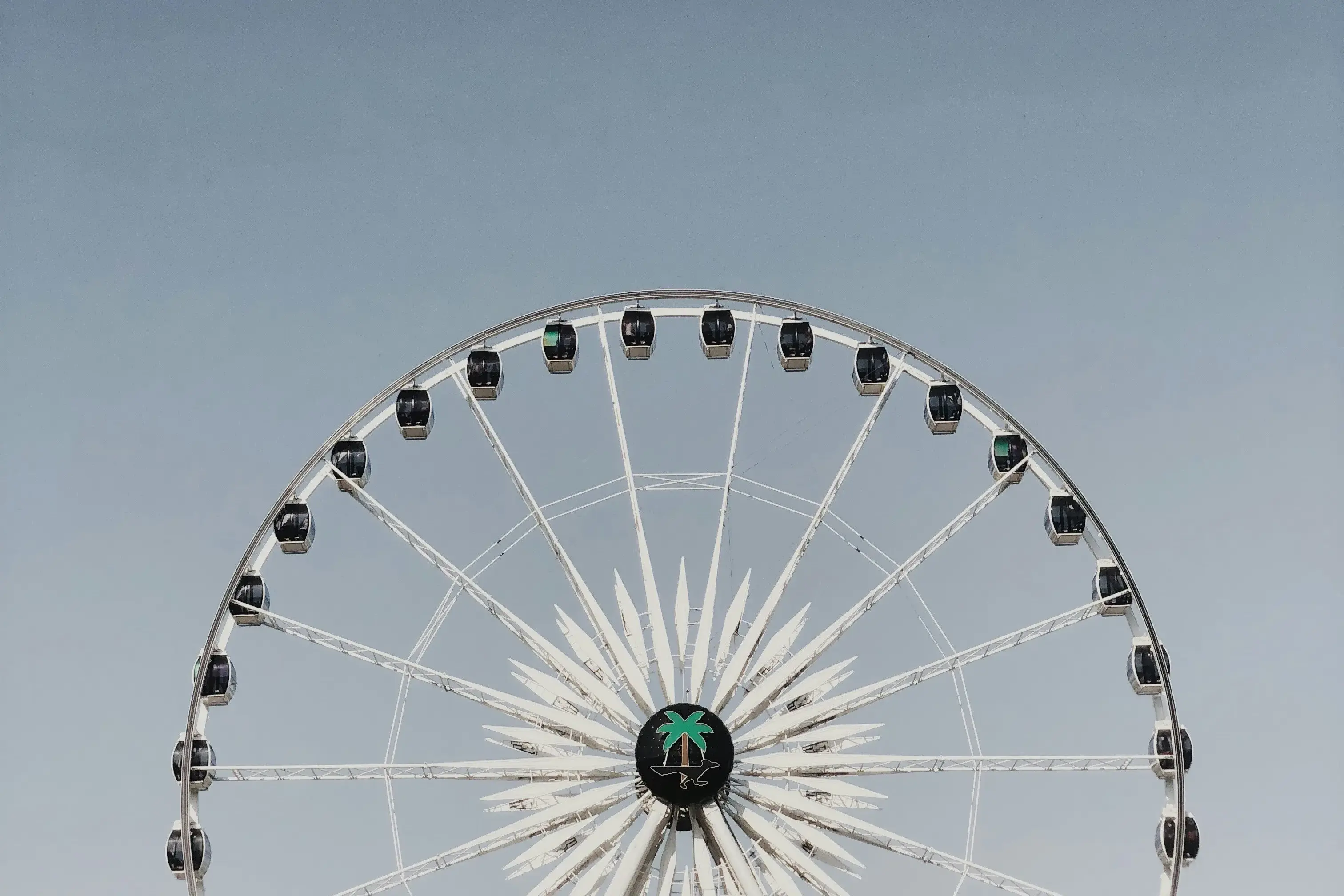 Ferris wheel against a clear blue sky with minimalistic composition at Coachella.