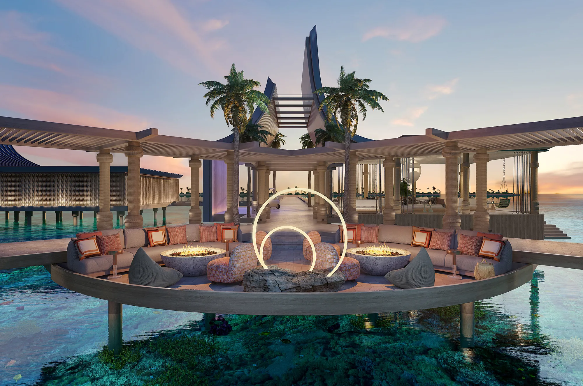 Observation deck at .Here Resort in the Maldives with circular seating over crystal-clear lagoon at sunset.