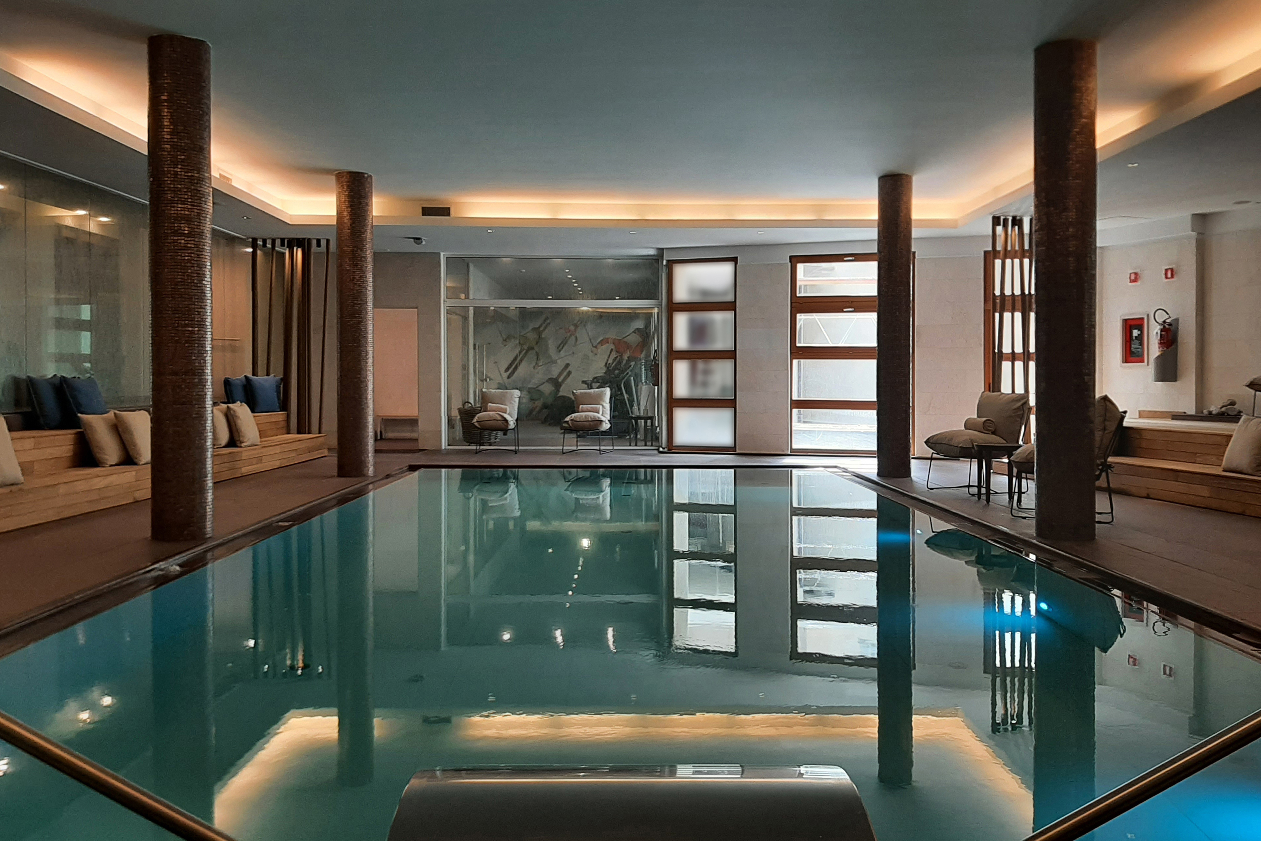 A view of the cosy low-lit spa at Grand Hotel Savoia looking over the pool to loungers on the other side