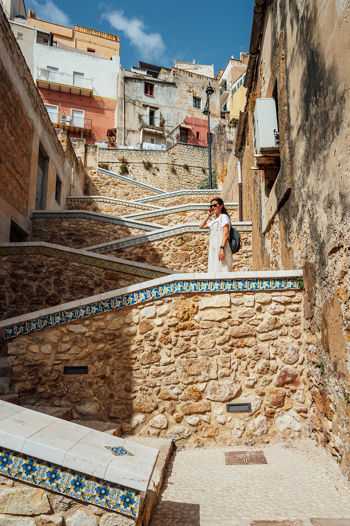 Woman stood on winding steps in Sciacca, Sicily