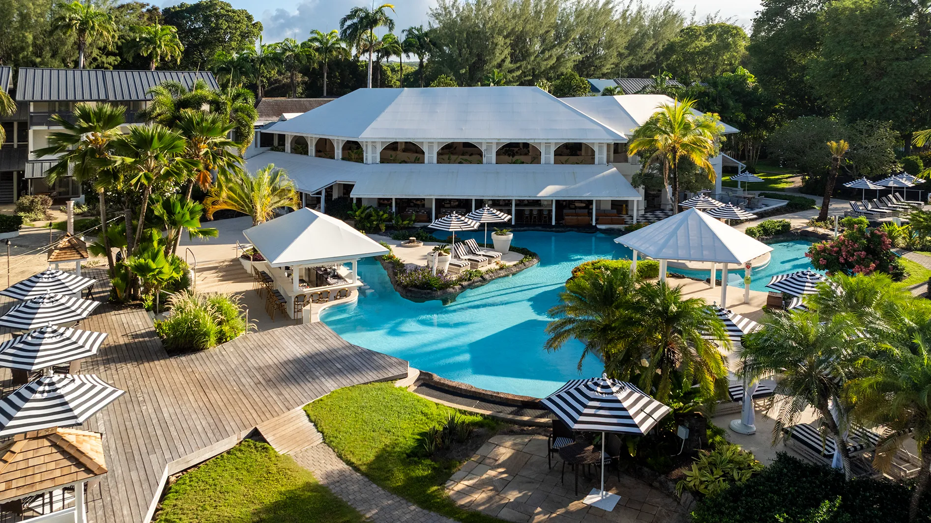 Caribbean, Barbados, Colony Club, view of pool surrounded by sun loungers and parasols