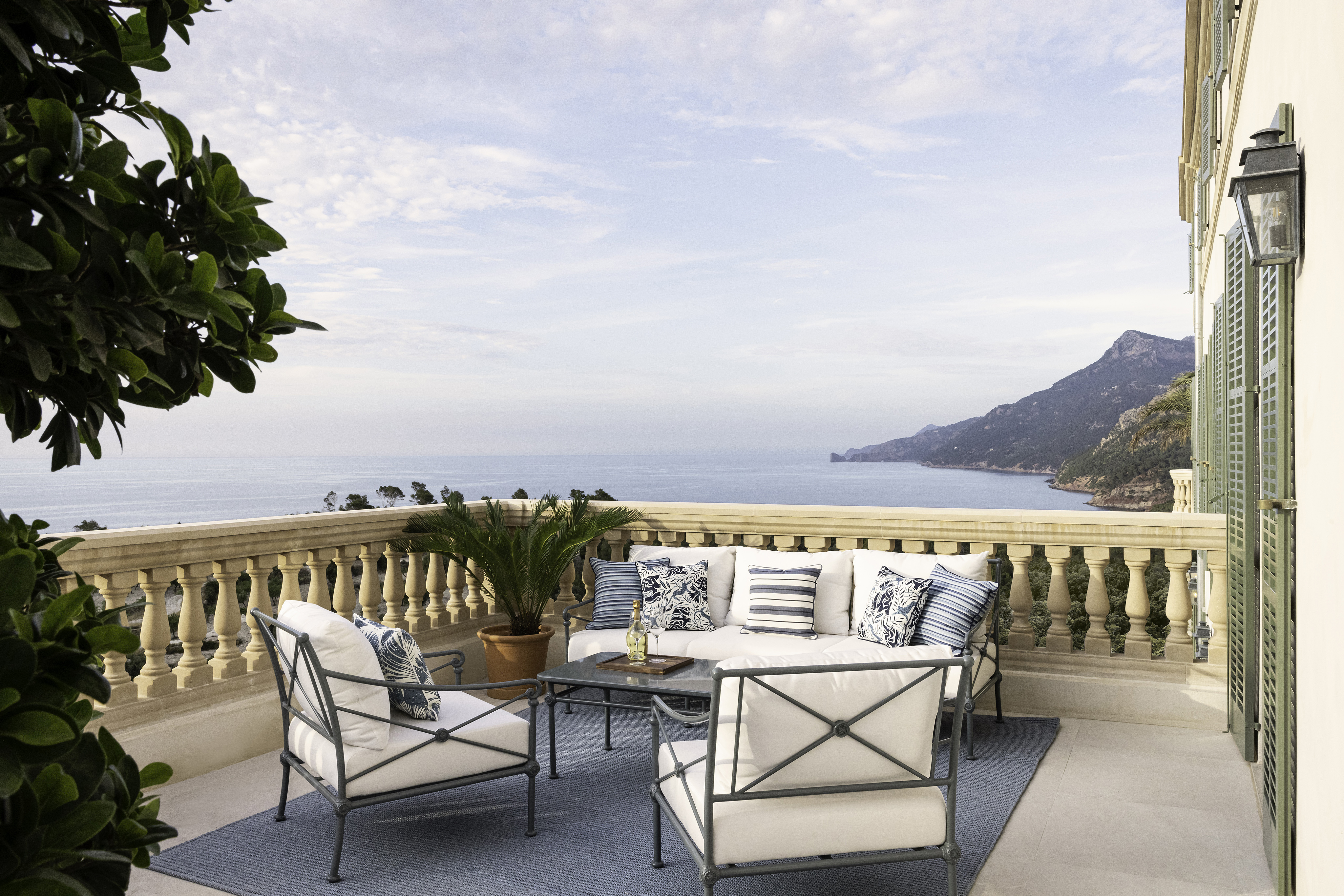 Deluxe Sea View Room Terrace with white furniture and green shutters