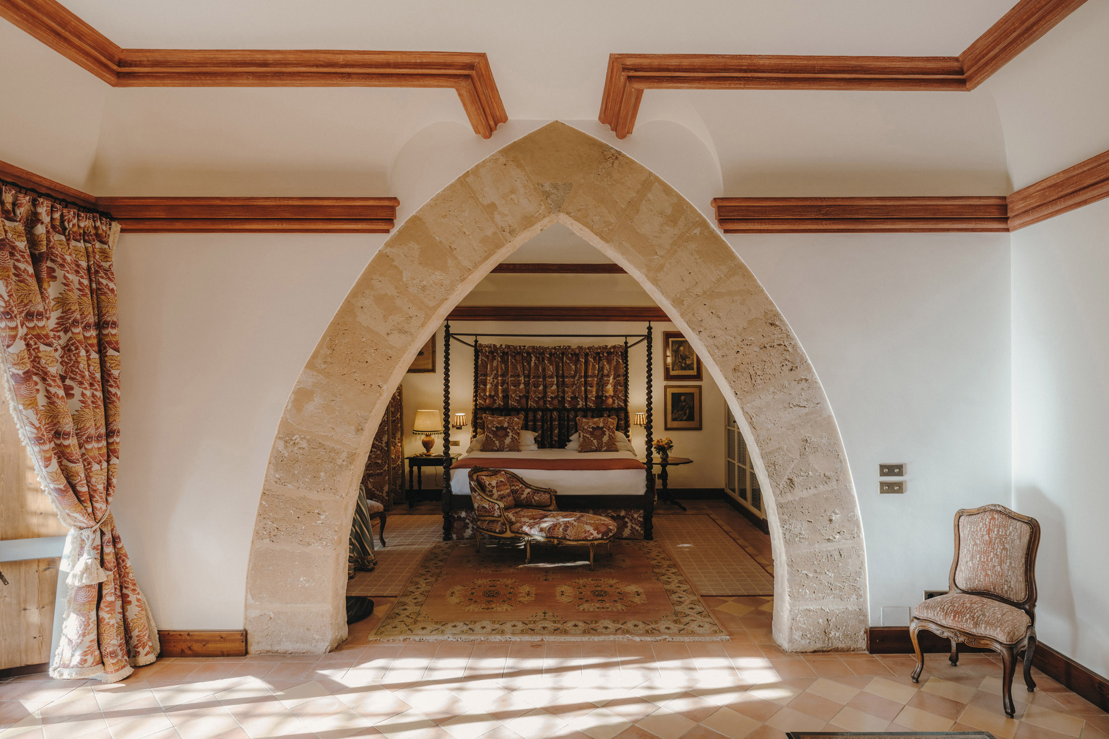 Stone archway in a Grand Suite looking into the bedroom