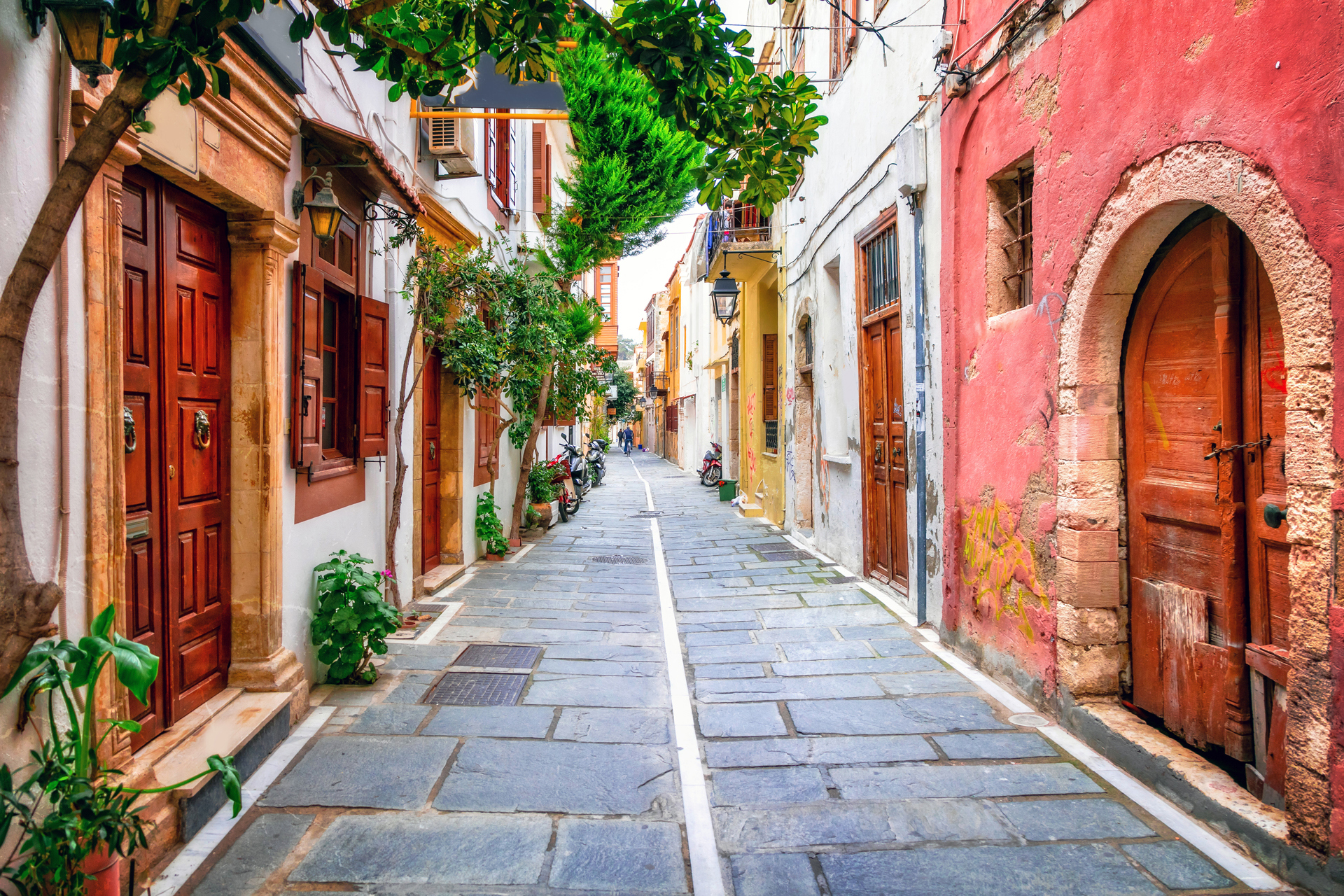 A small street lined by buildings with wooden doors