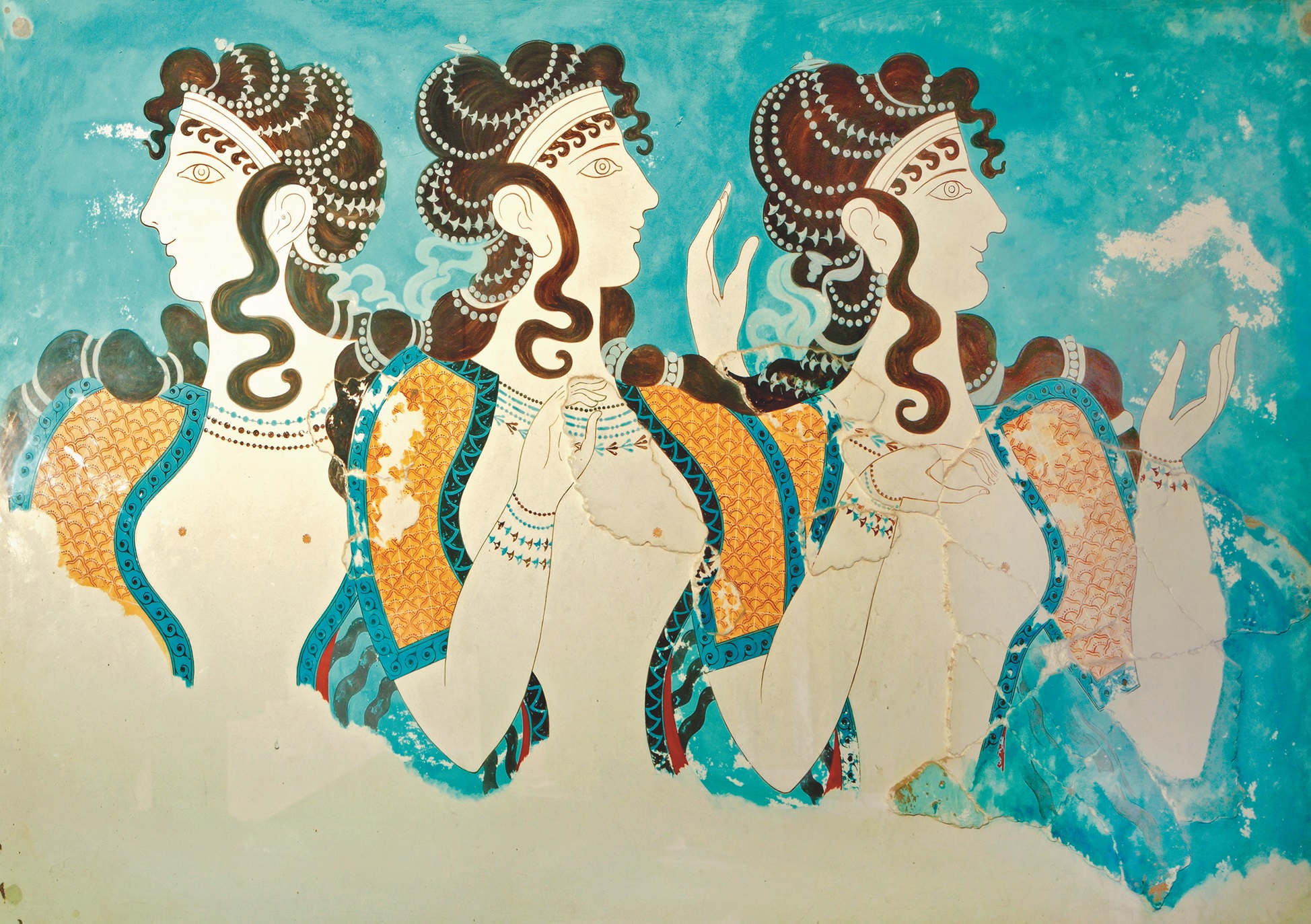 A restored ancient fresco from the Palace of Knossos in Crete shows three elegant women with flowing hair and detailed clothing, offering a cultural glimpse into Minoan civilization for curious family travelers
