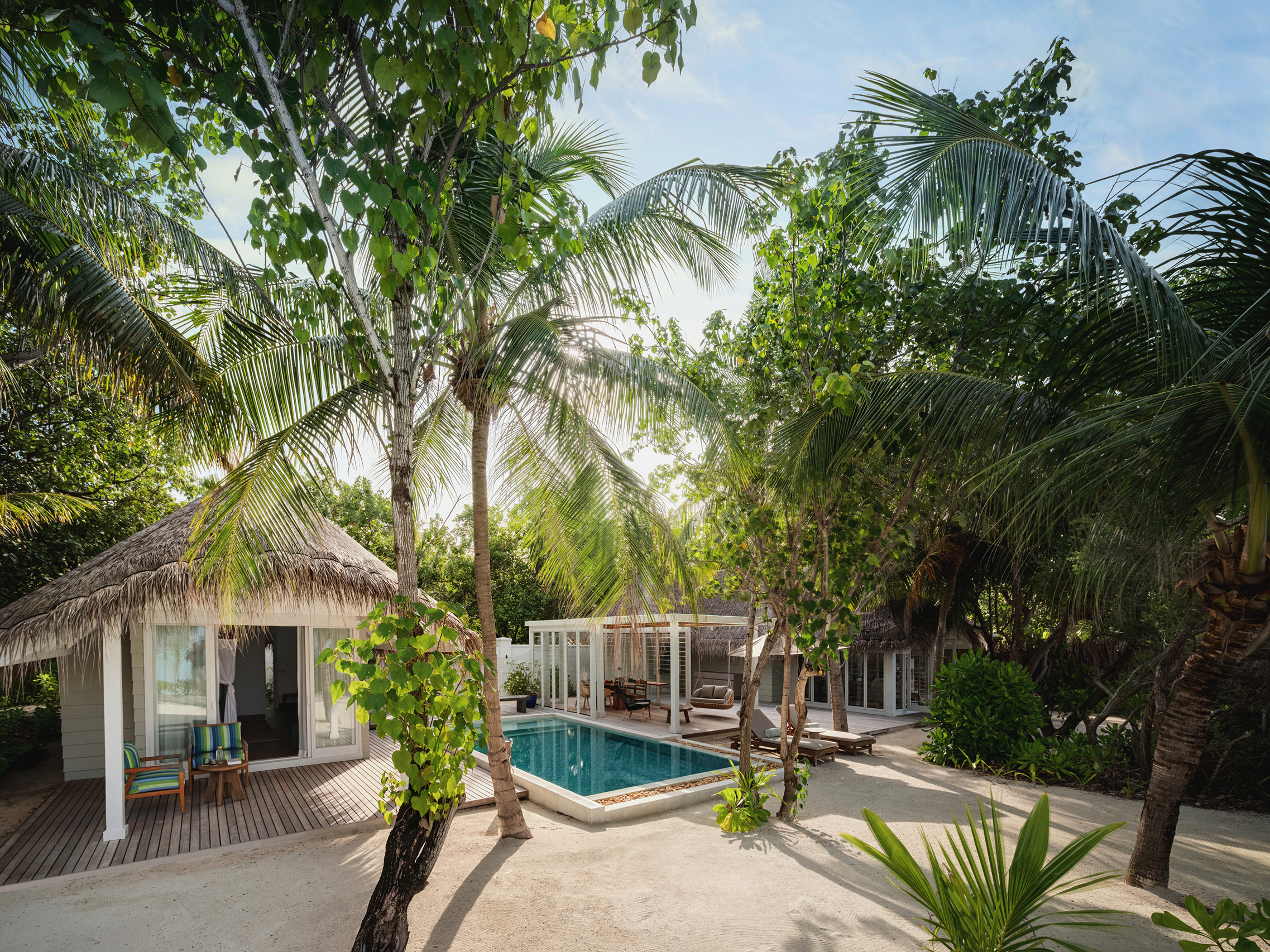 Pool surrounded by foliage in the two bedroom beach villa at Six Senses Kanuhura