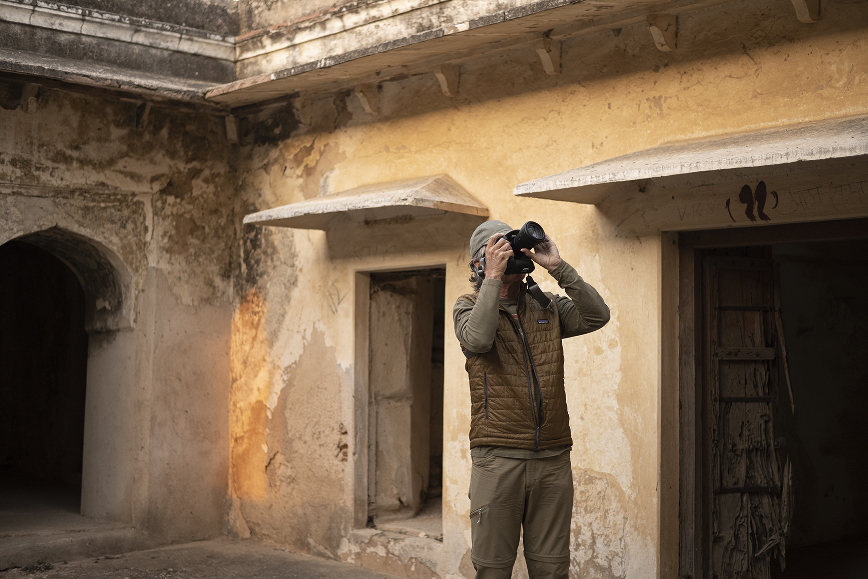 Asia, India, man taking a photo inside a courtyard