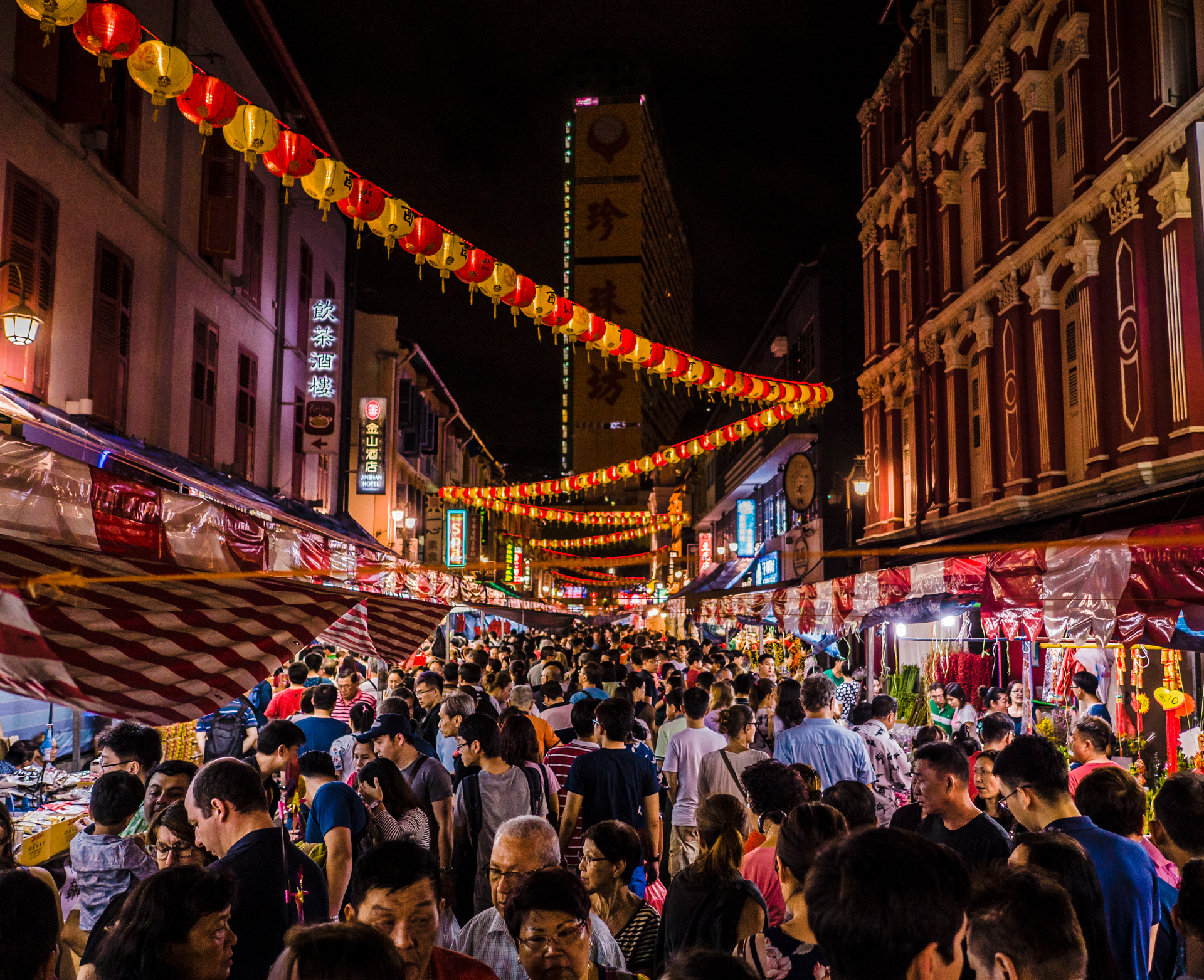 A busy Singapore market street at night