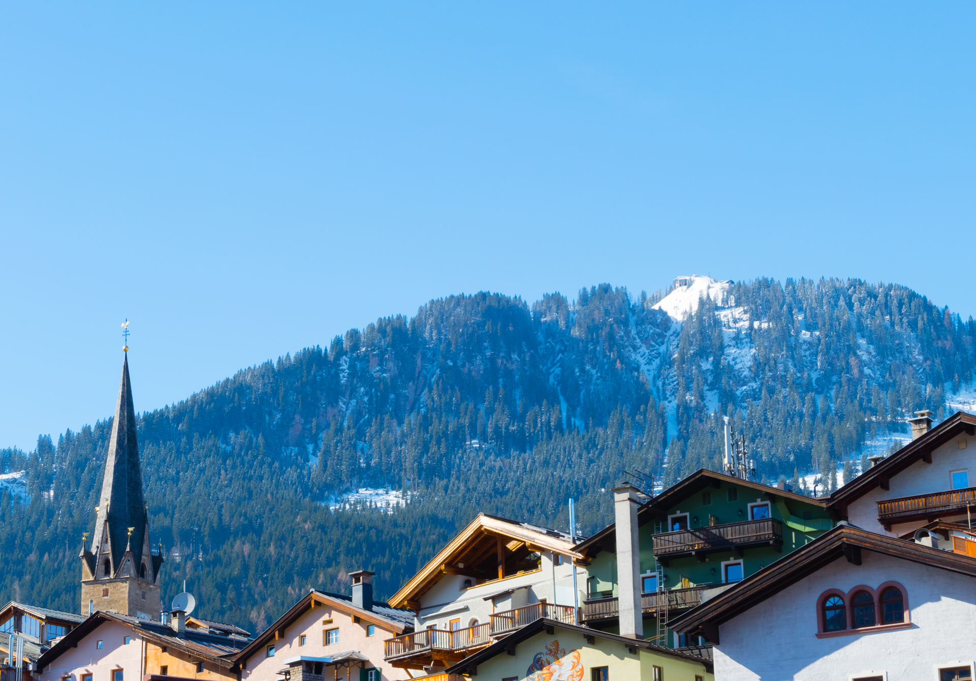 The roofs of a church and lodges in Kitzbuehel